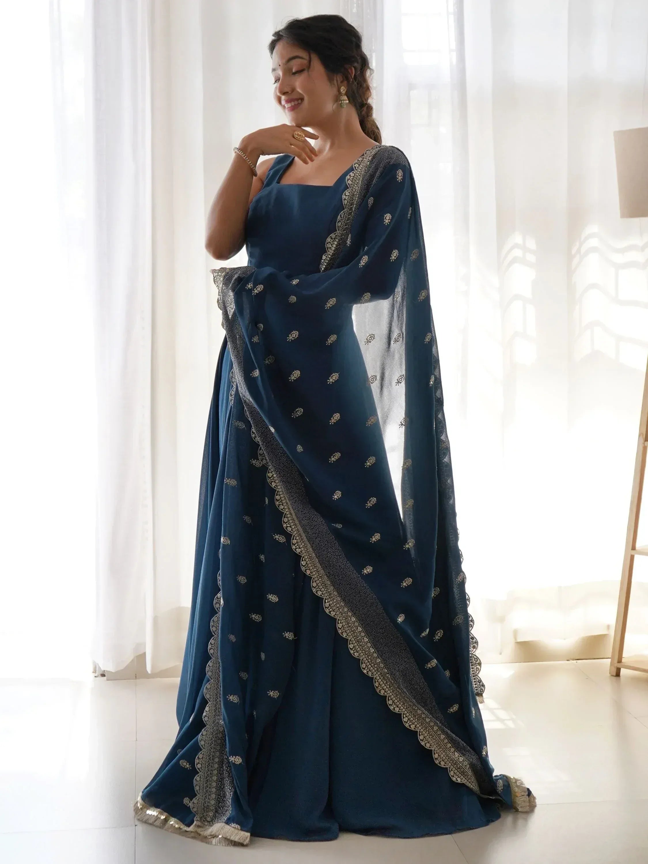 Elegant navy blue ethnic gown with gold embroidery and scalloped dupatta, perfect for Indian occasions