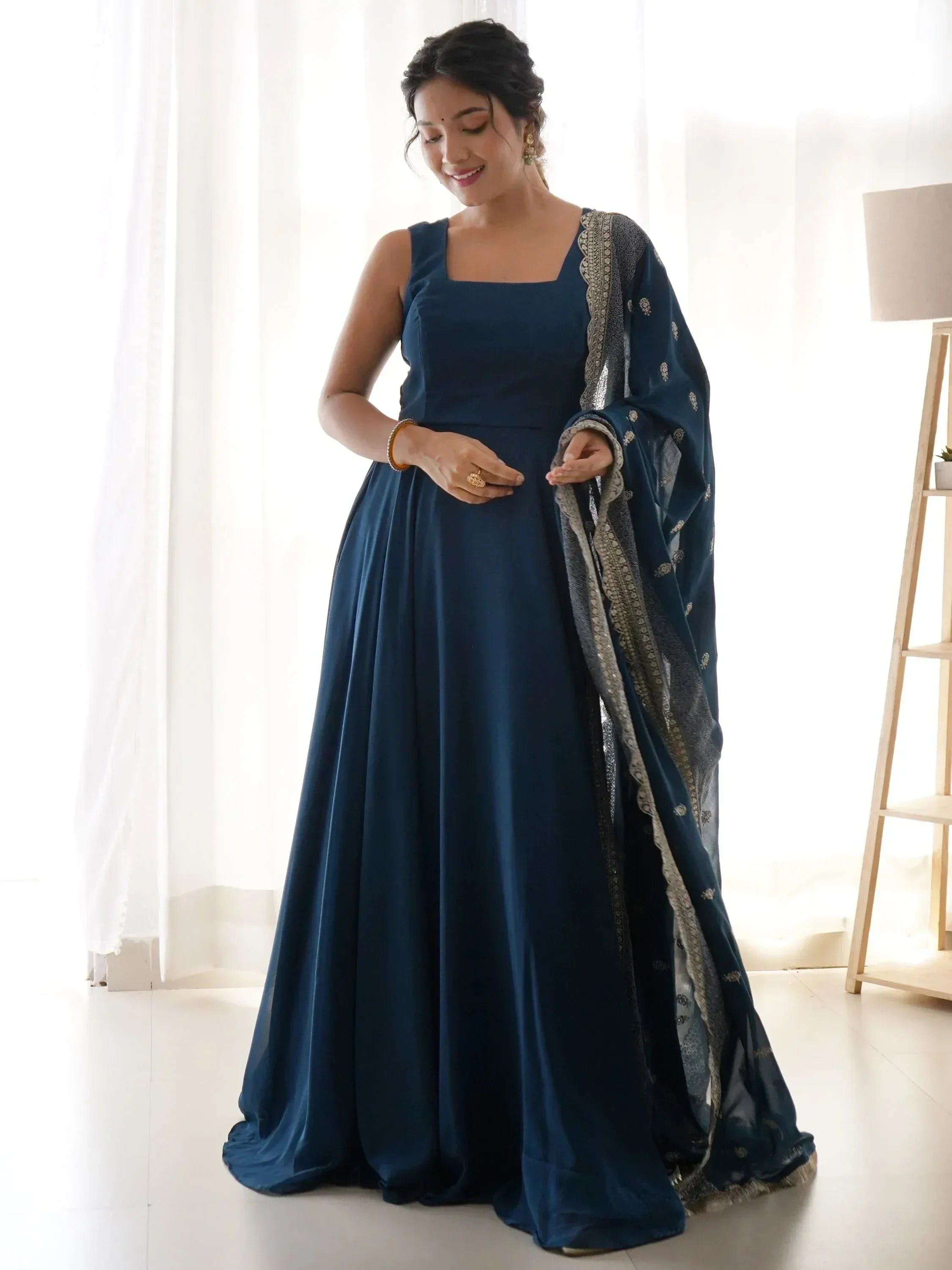 Elegant navy blue ethnic gown with embroidered dupatta, perfect for Indian occasions and festive wear.