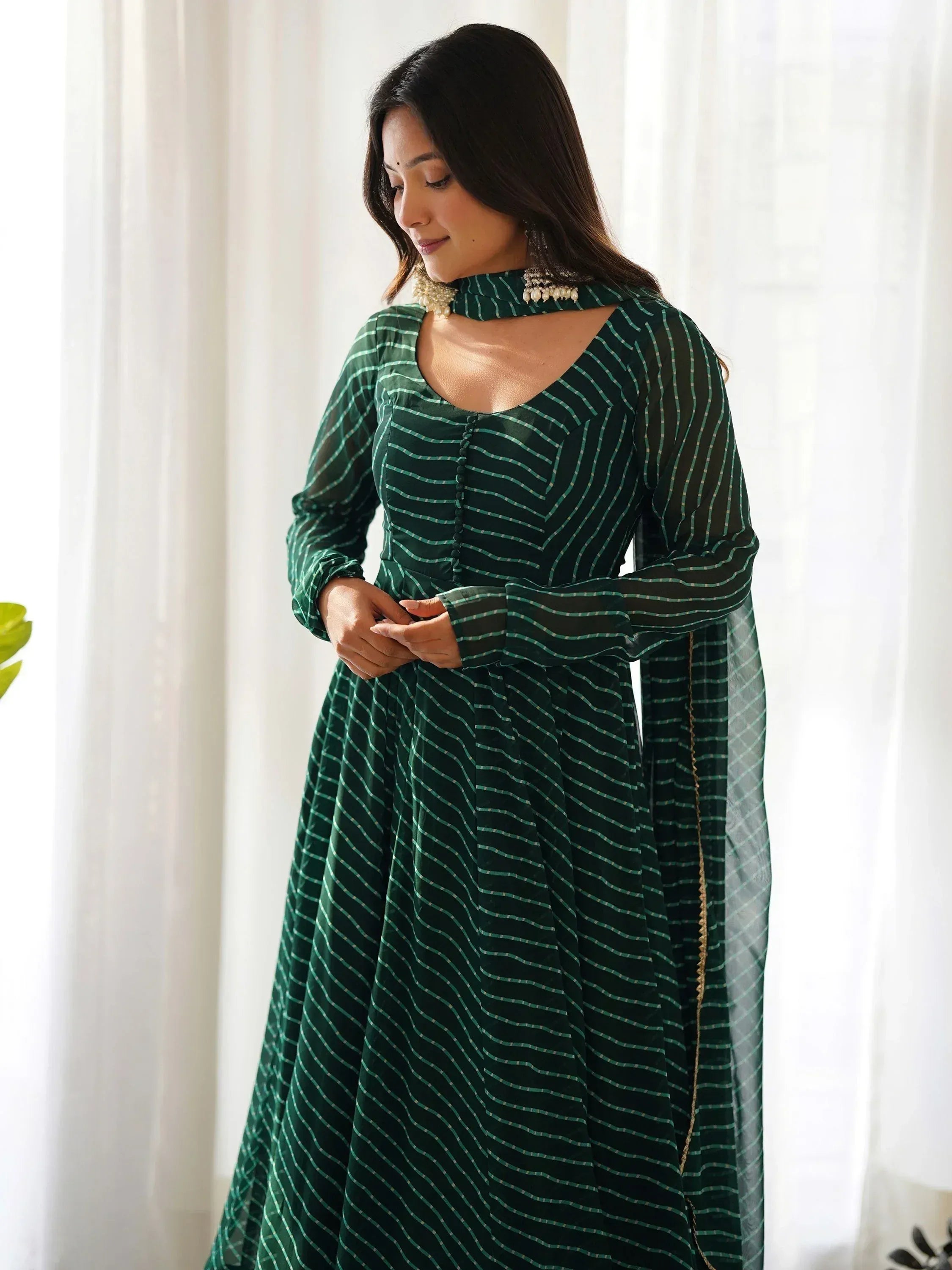 Green striped ethnic gown with sheer sleeves and choker neckline, perfect for Indian occasions