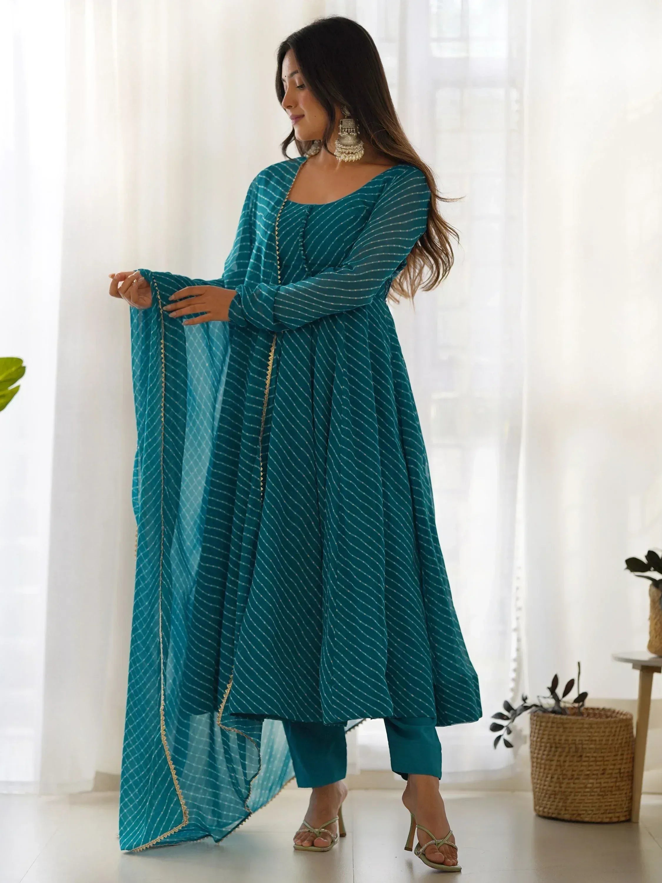 Teal striped ethnic kurta with matching pants and dupatta, styled with jhumka earrings for Indian wear