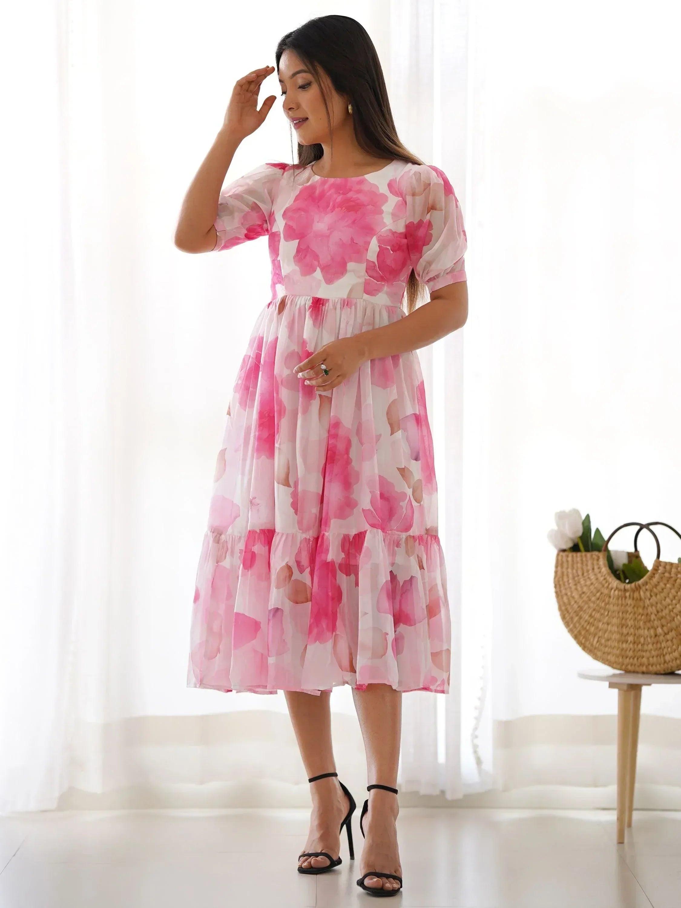 Pink floral ethnic gown with puff sleeves and tiered skirt, perfect for festive occasions