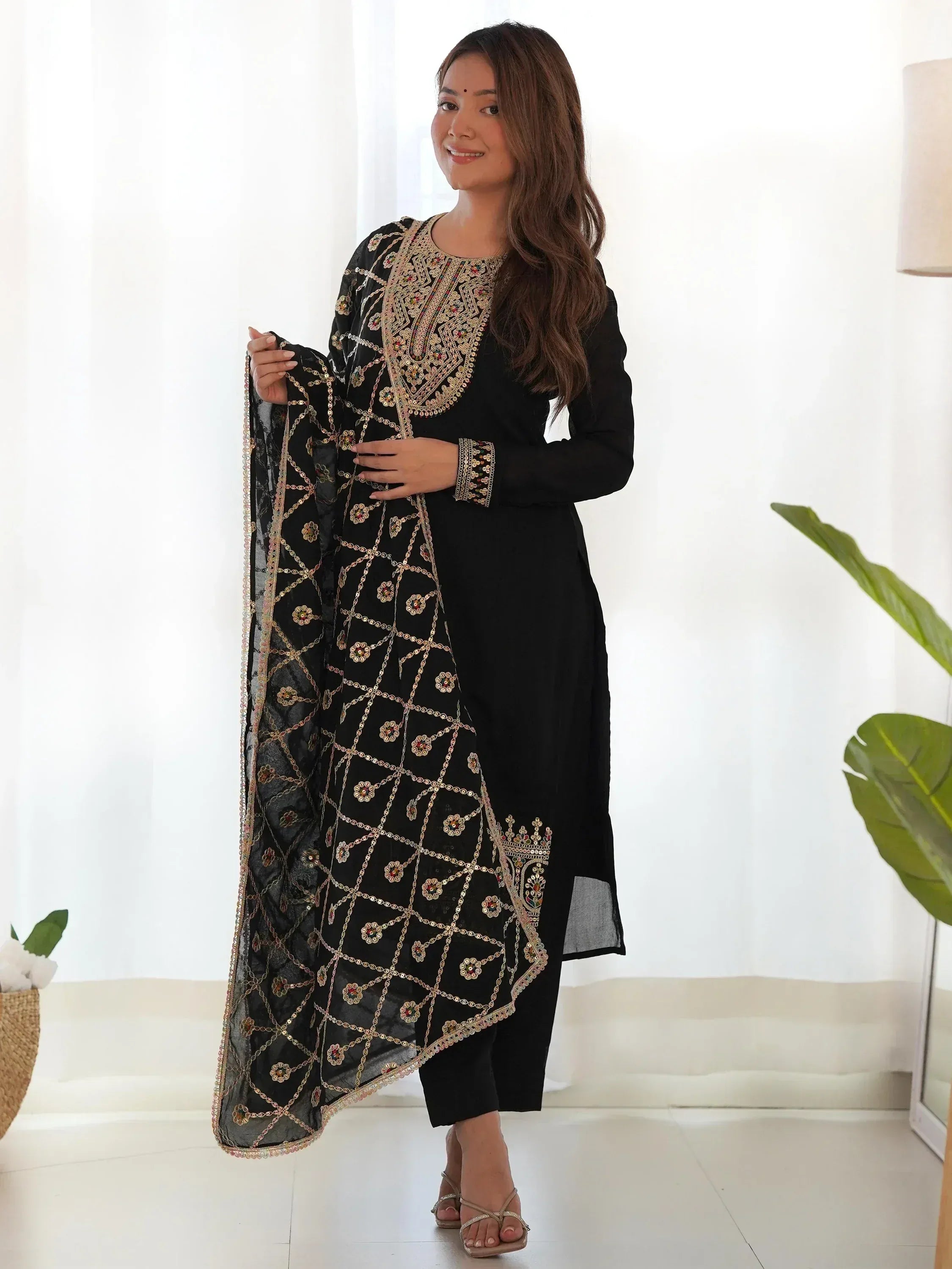 Black embroidered salwar kameez with gold mirror work and matching dupatta, ideal for Indian ethnic wear