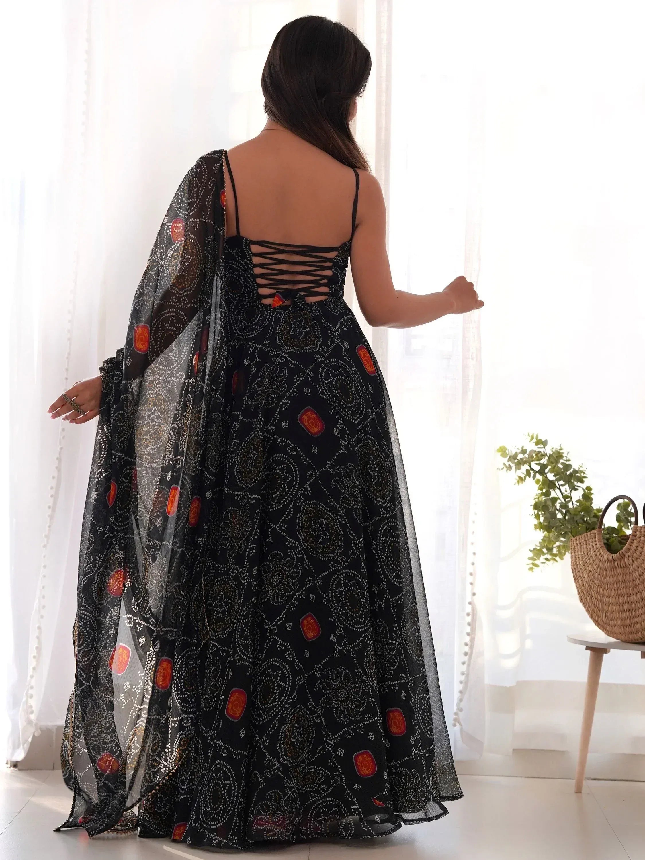 Black printed ethnic gown with lace-up back and sheer dupatta, perfect for Indian occasions