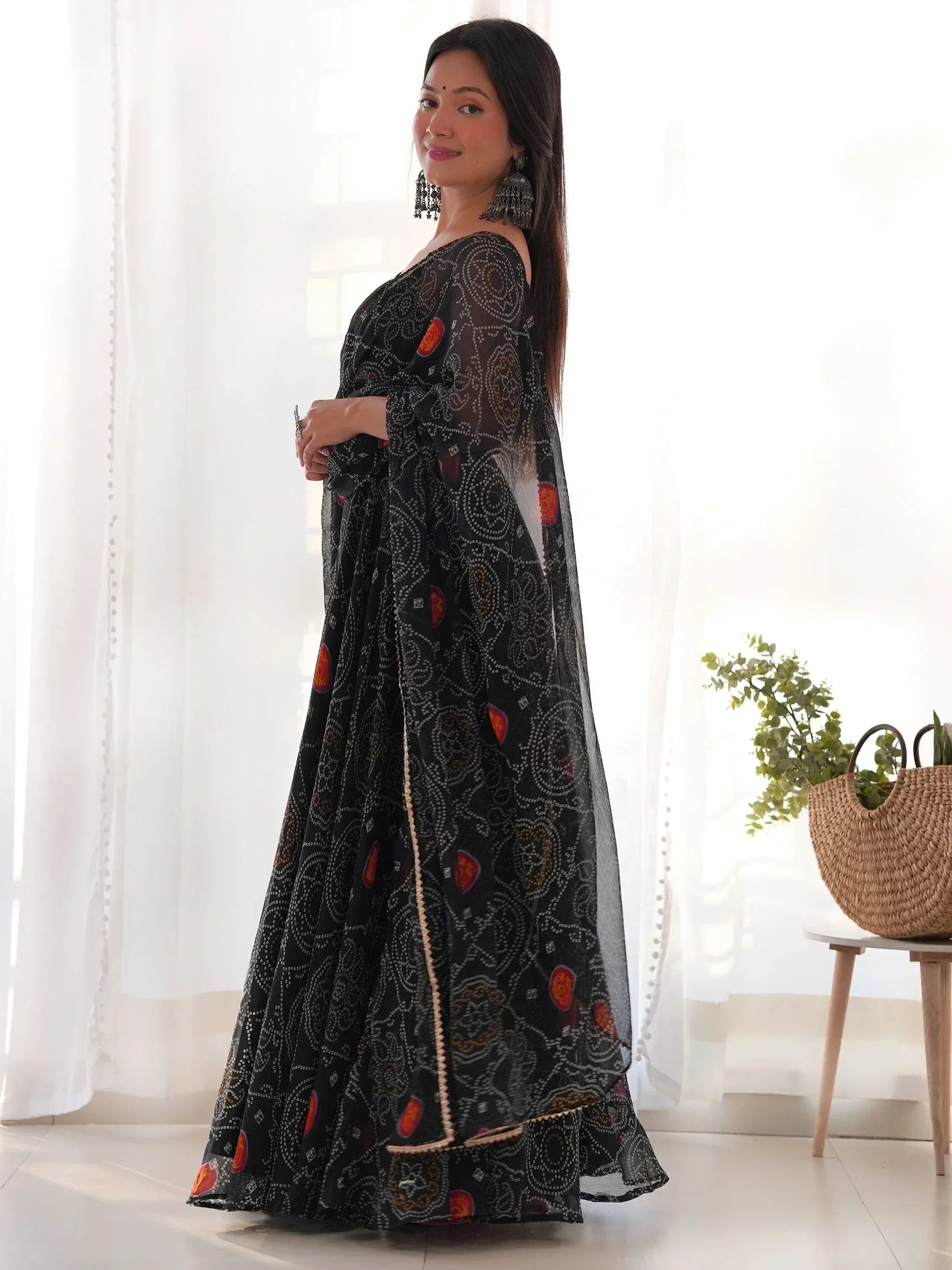 Black printed ethnic gown with off-shoulder design and sheer sleeves, perfect for Indian occasions