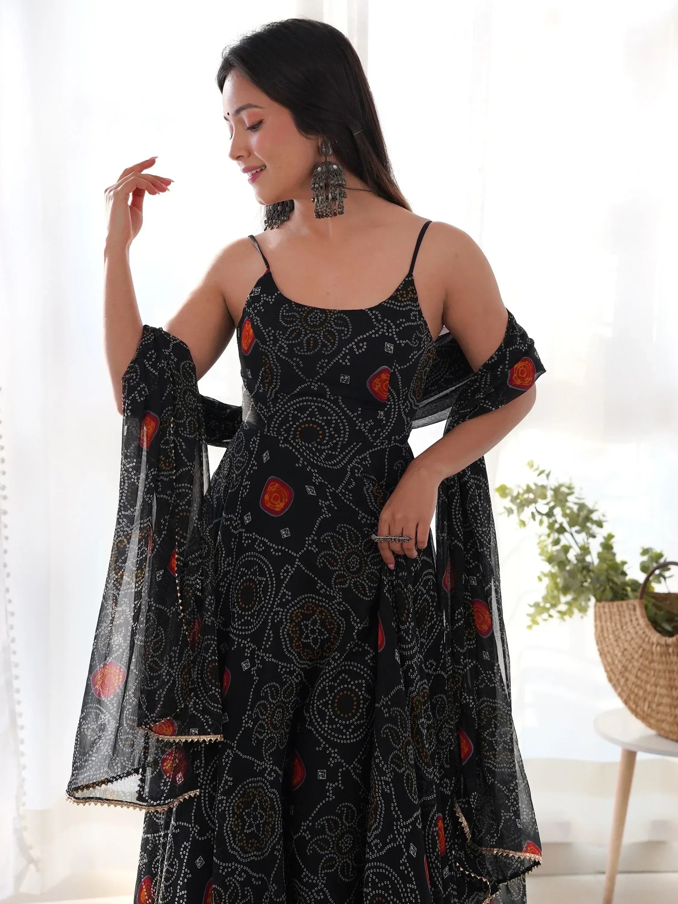 Black printed ethnic gown with cold shoulder sleeves and floral motifs, perfect for Indian occasions
