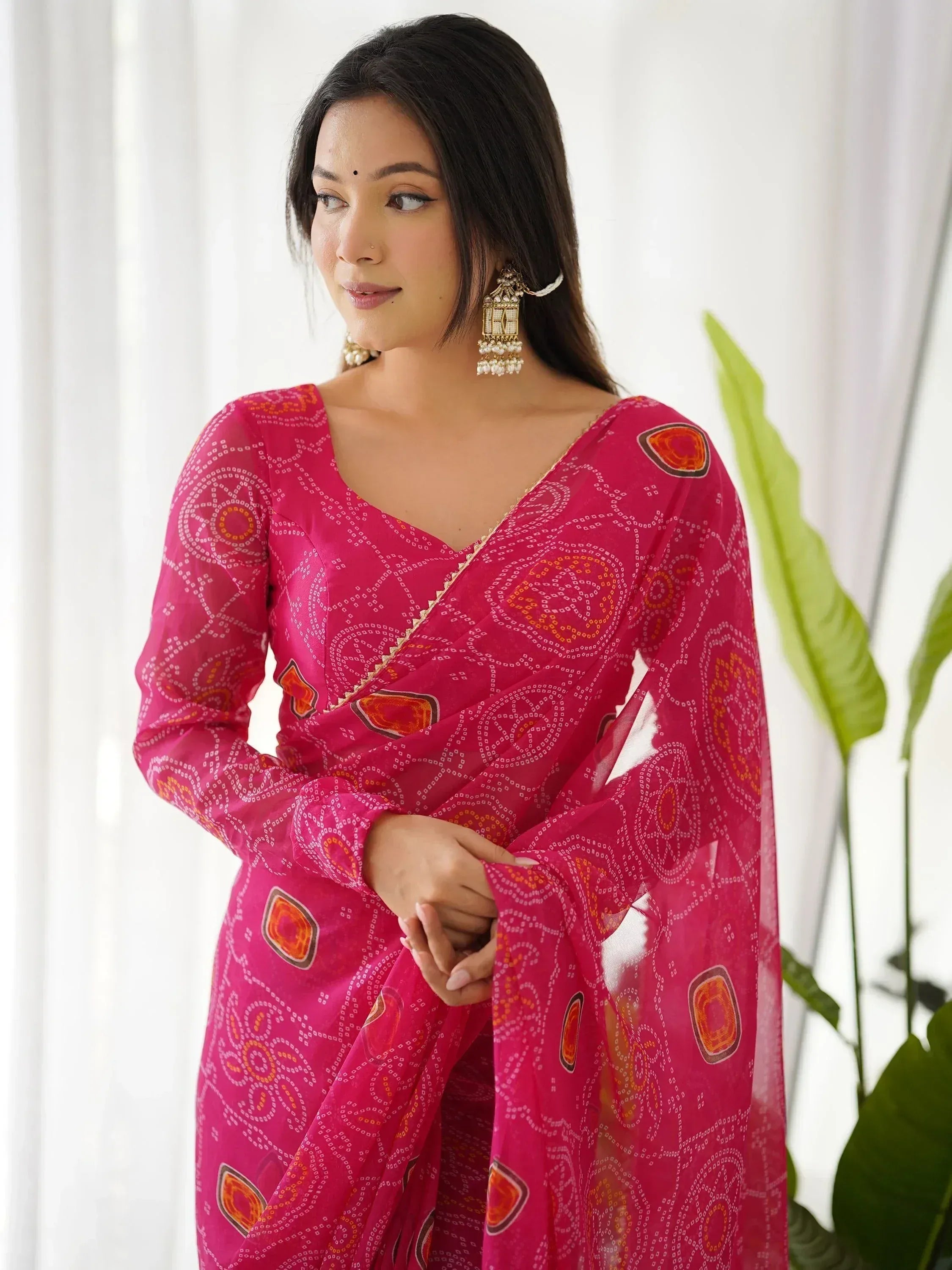 Pink printed saree with geometric patterns, perfect for Indian ethnic wear and festive occasions.