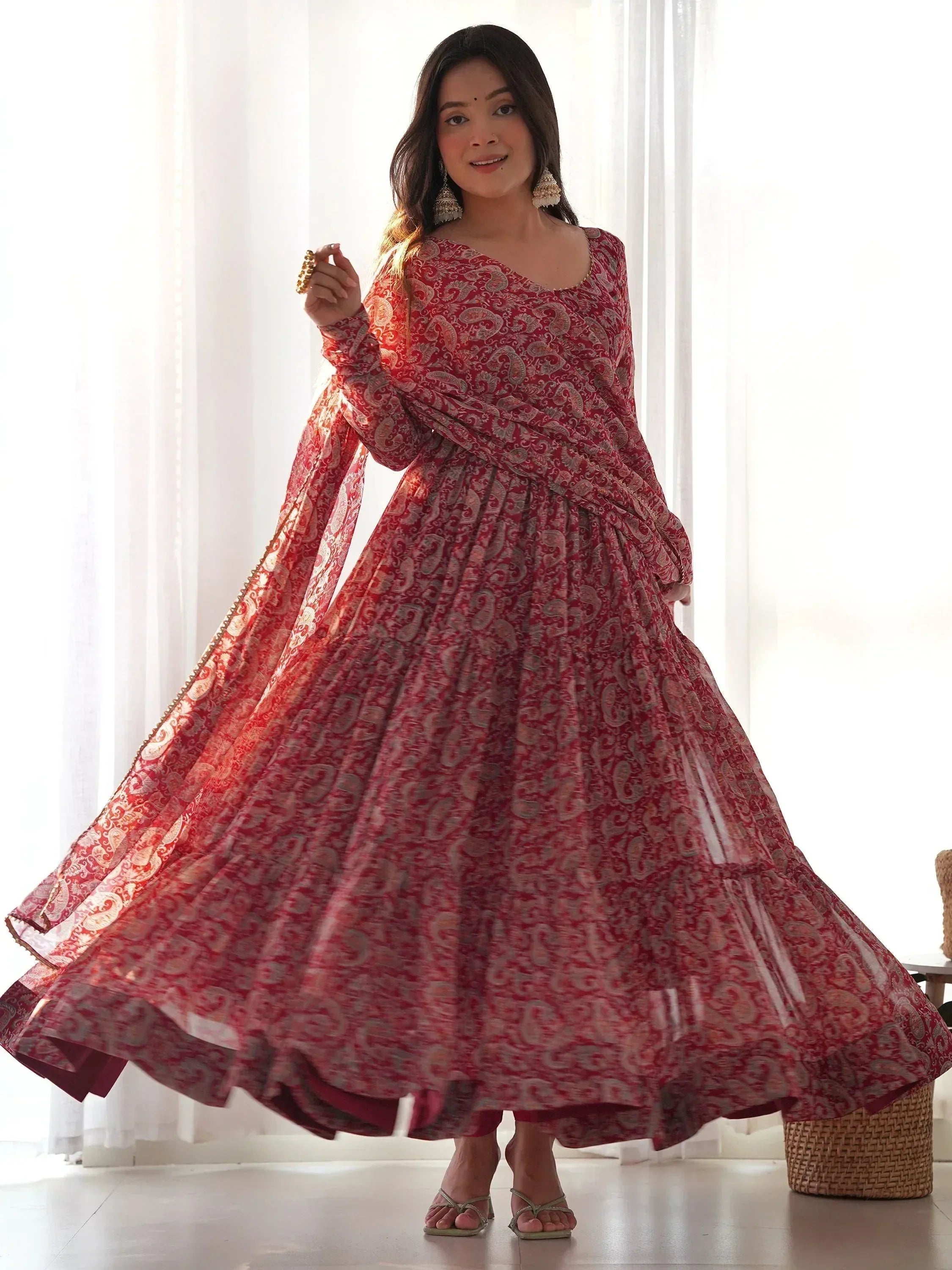 Red paisley print ethnic gown with flared skirt and long sleeves, perfect for Indian occasions