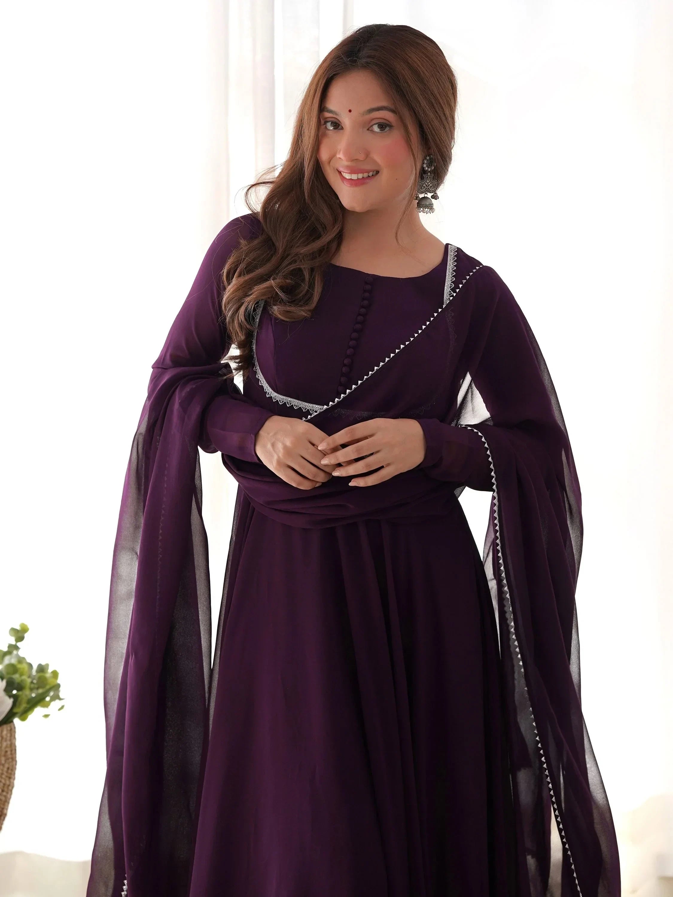 Woman in purple ethnic gown with dupatta and silver earrings, Indian traditional wear