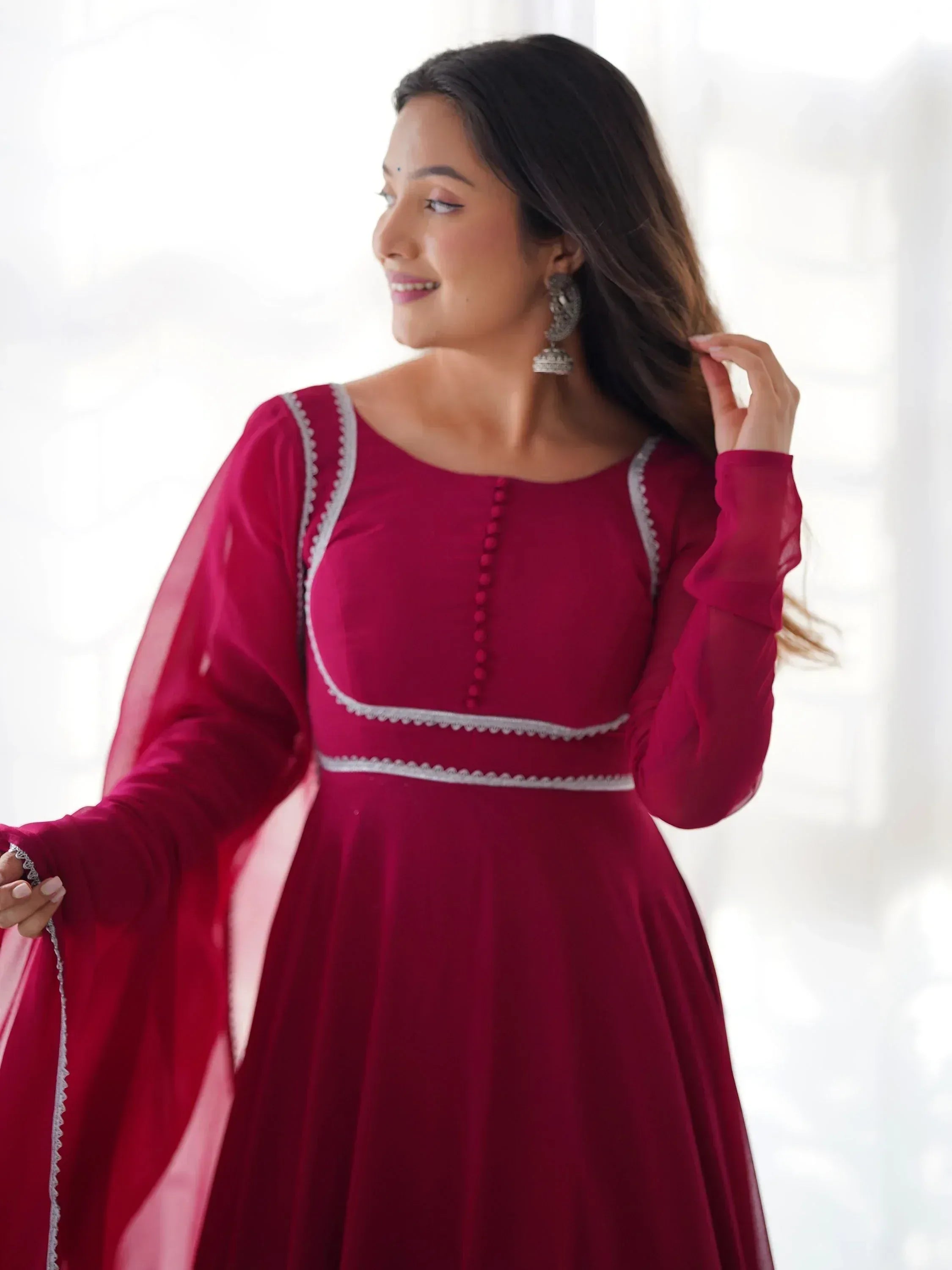 Woman in maroon ethnic gown with silver embroidery, perfect for Indian occasions