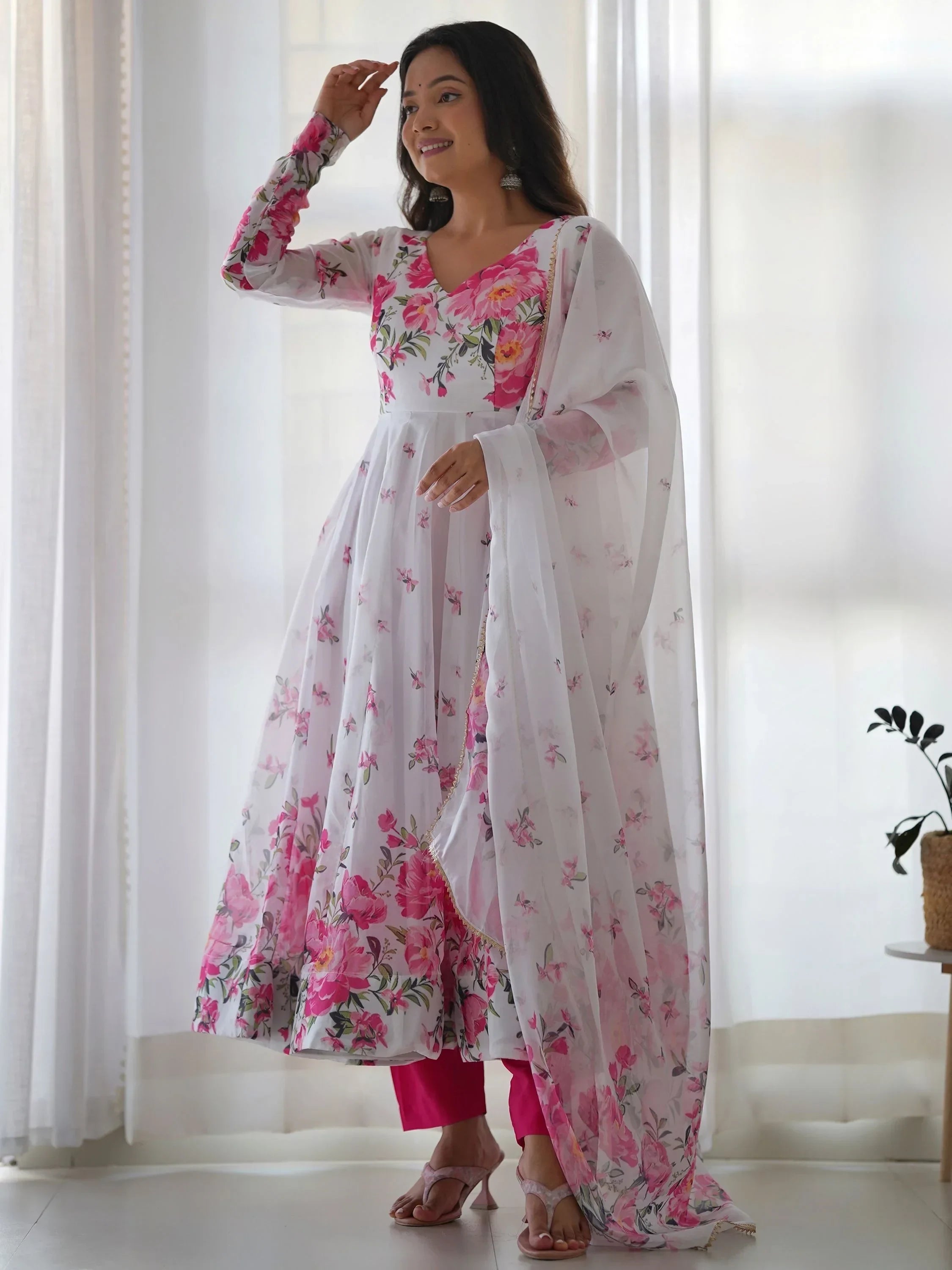Woman in floral print Anarkali suit with pink and white dupatta, Indian ethnic wear