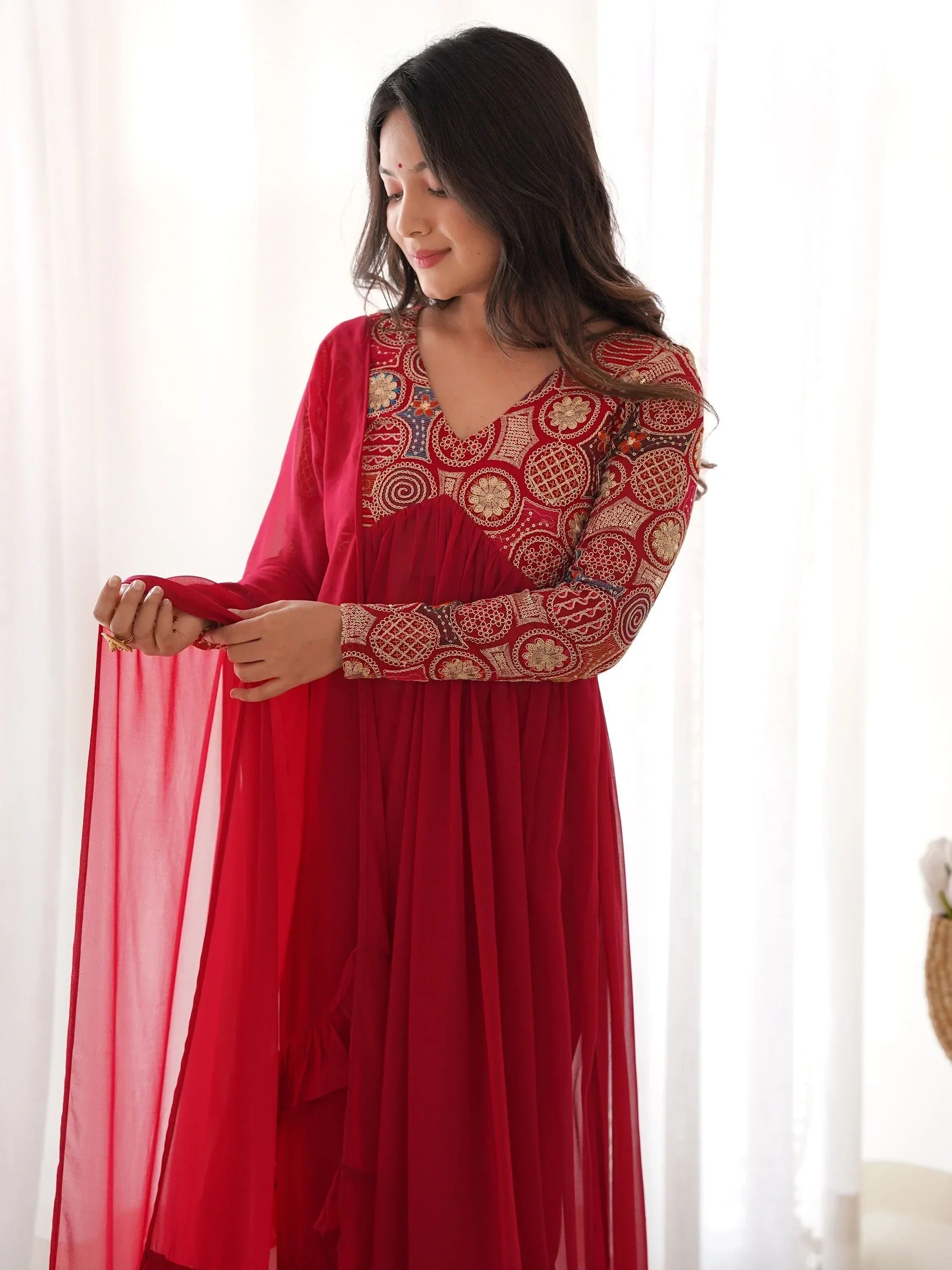 Woman in red embroidered ethnic gown with sheer dupatta, Indian festive wear