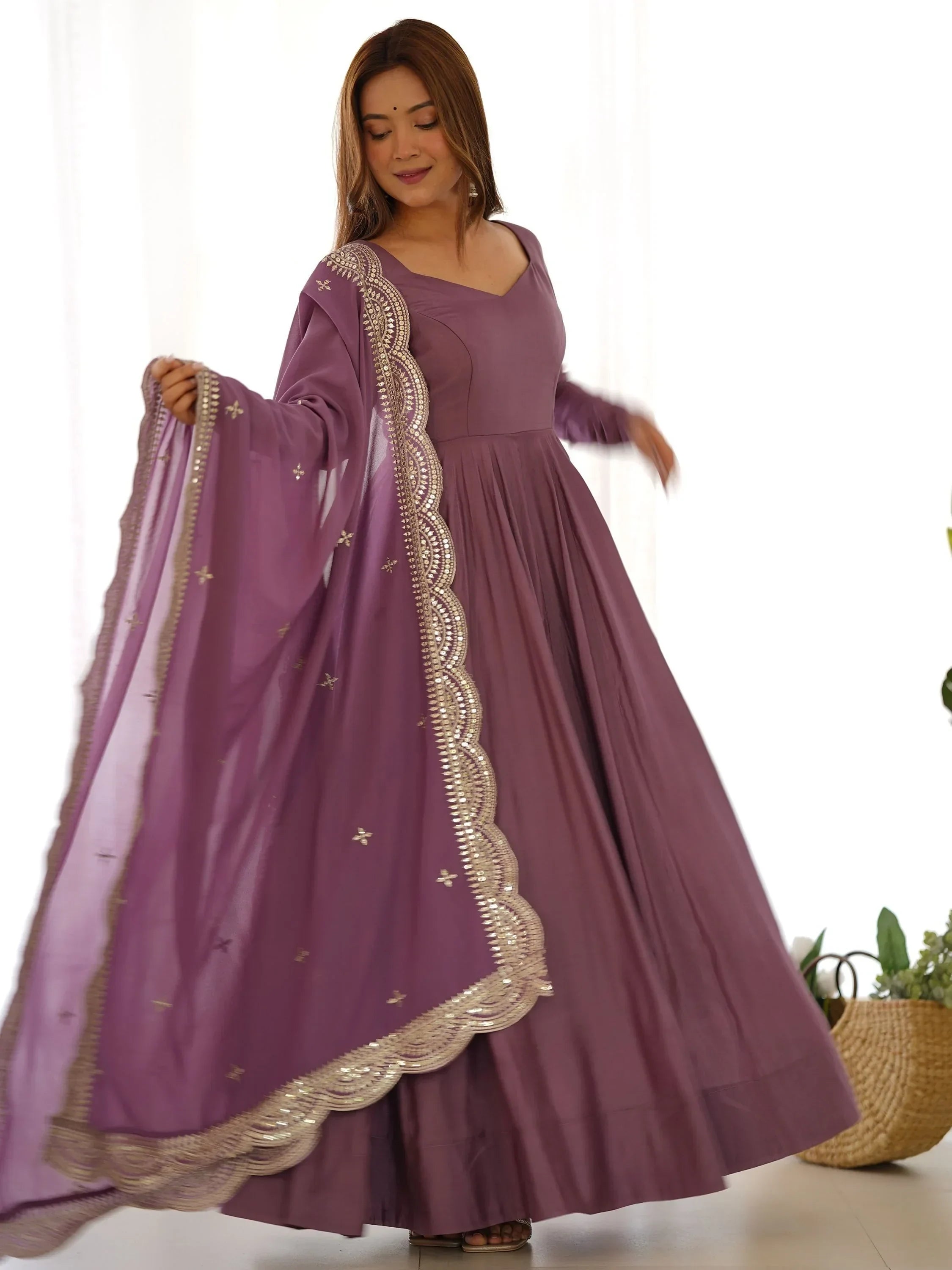 Woman in mauve ethnic gown with embellished dupatta, Indian party wear outfit