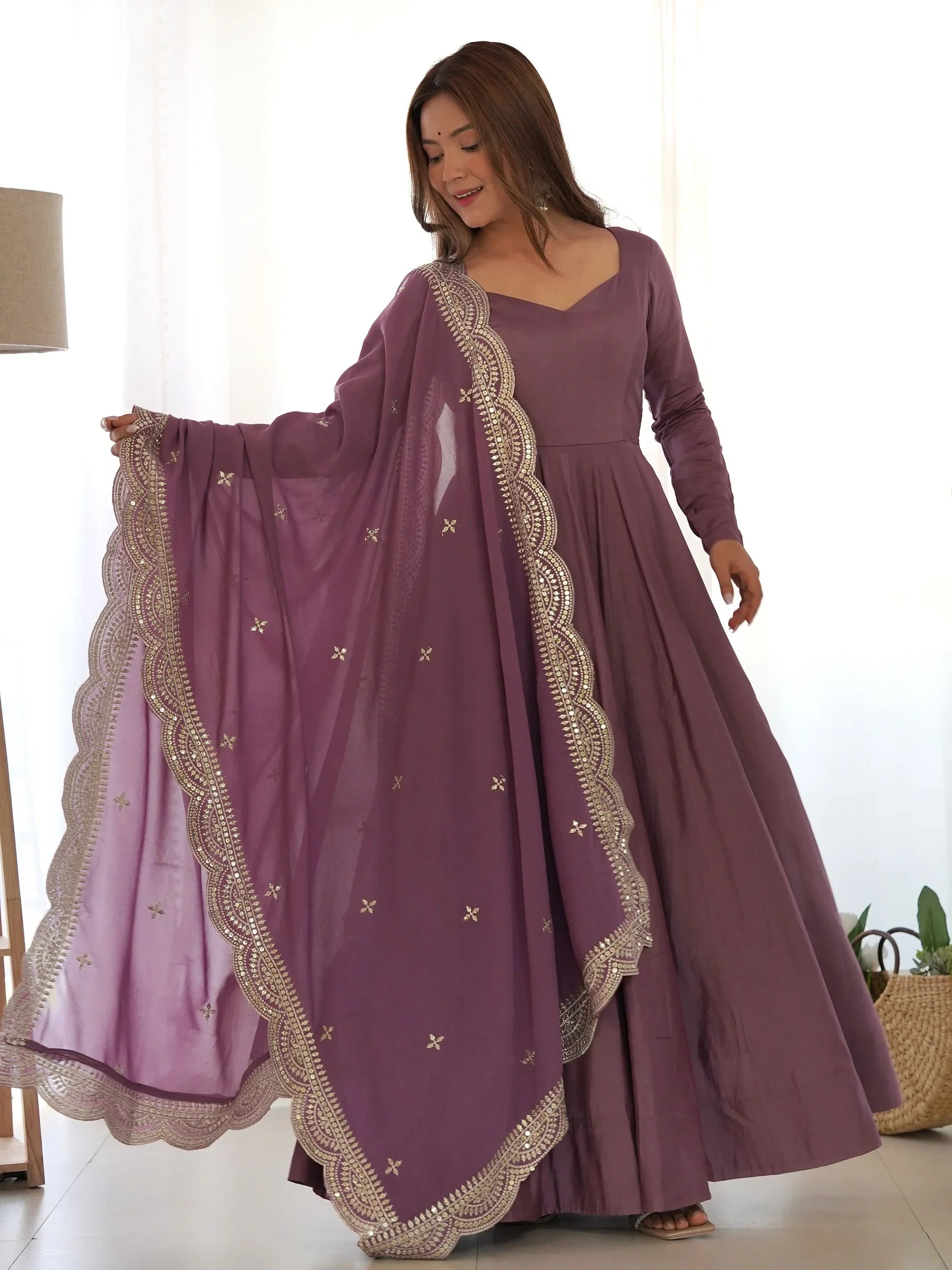 Woman in mauve Anarkali suit with embroidered net dupatta, Indian ethnic dress fashion