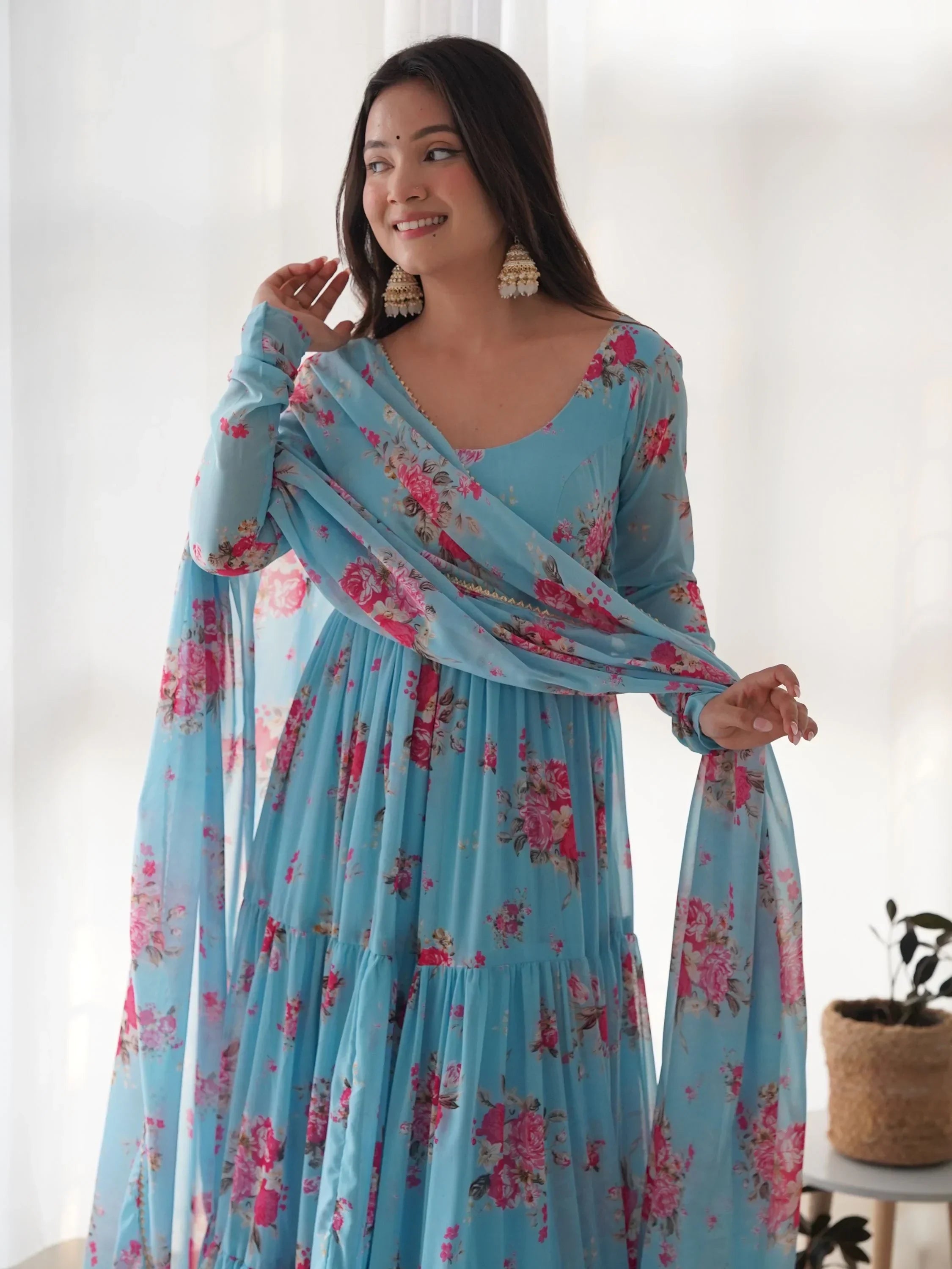 Woman in blue floral Anarkali suit with dupatta, traditional Indian ethnic wear