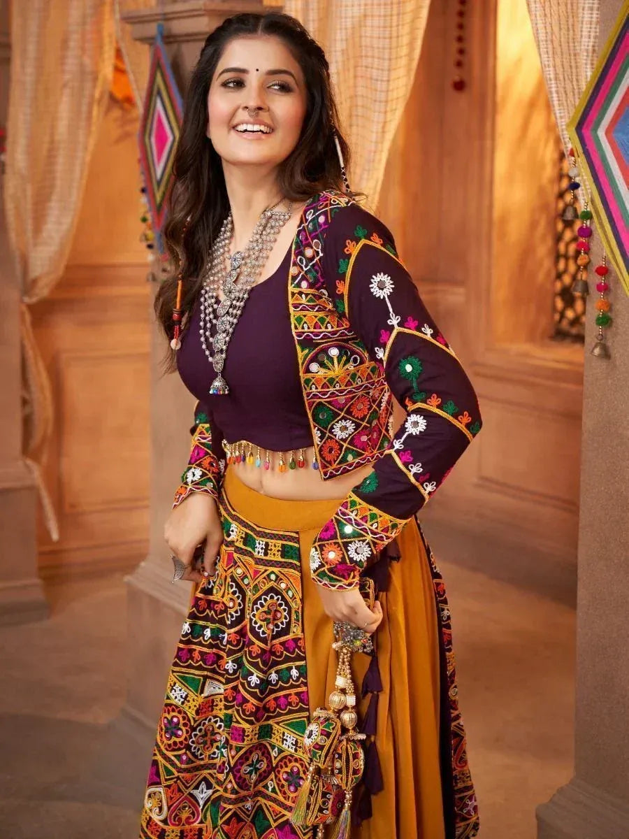 Woman in vibrant embroidered Indian lehenga choli with mirror work, perfect for festive occasions