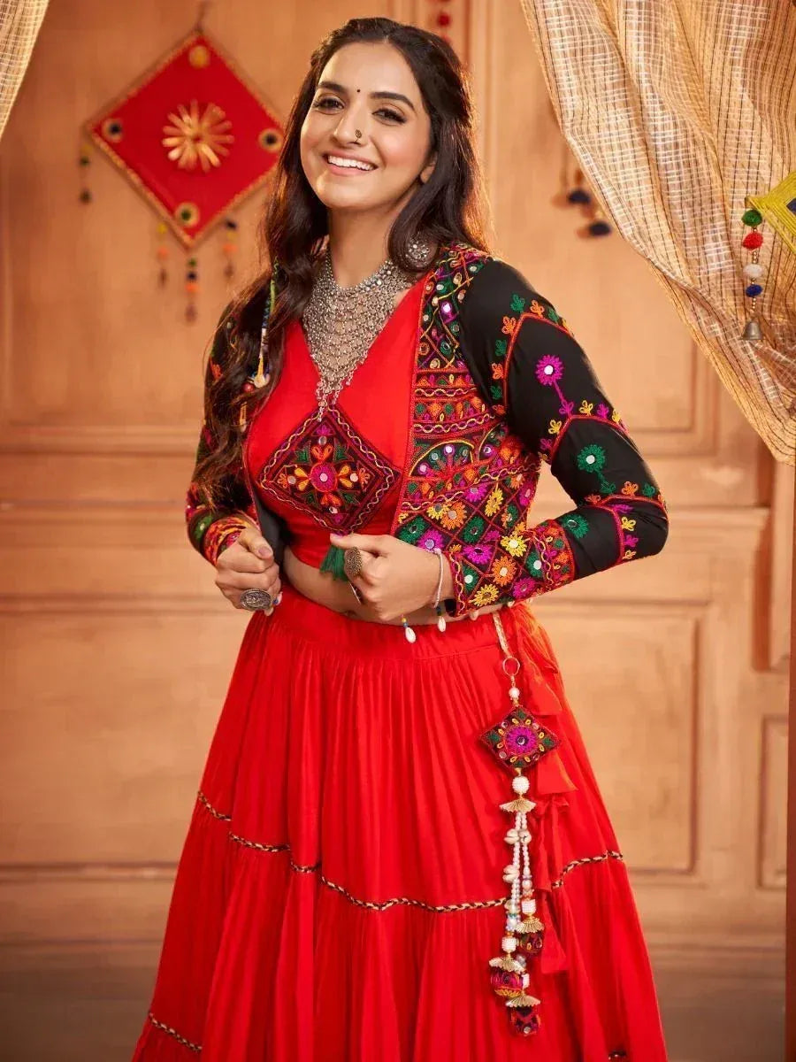 Vibrant red embroidered lehenga choli with black floral jacket, perfect for Indian ethnic occasions