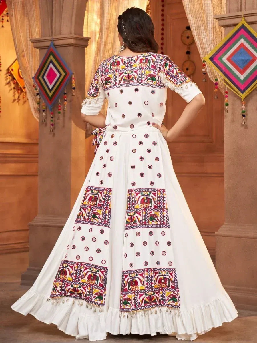 White embroidered ethnic gown with colorful patchwork and mirror work, perfect for Indian celebrations