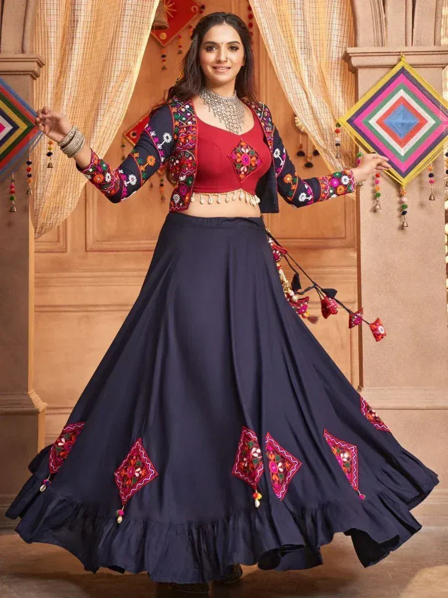 Woman in navy blue embroidered lehenga choli with floral motifs, perfect for Indian ethnic wear occasions