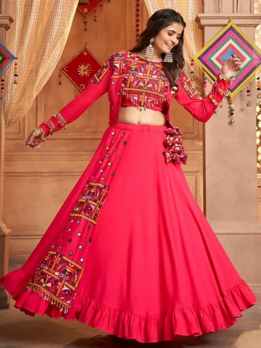 Vibrant red ethnic lehenga choli with intricate embroidery and mirror work, perfect for festive occasions