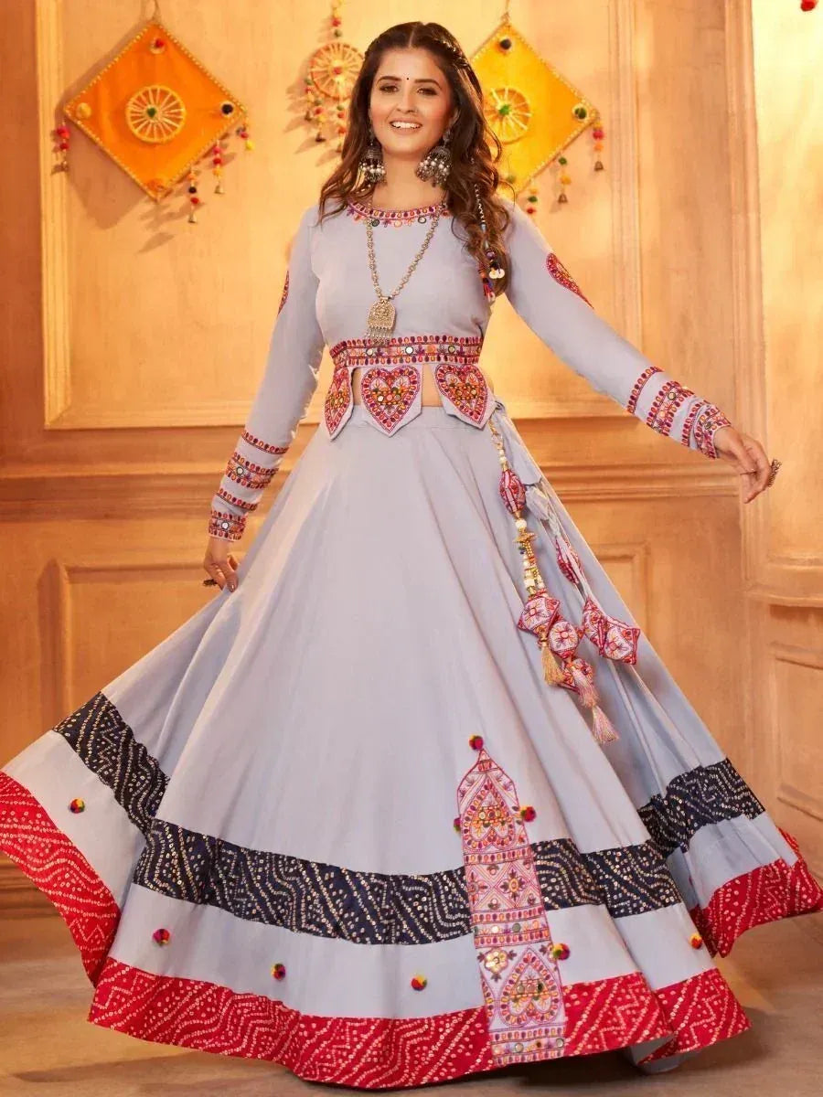 Light blue designer lehenga choli with mirror work, heart motifs, and red-black border, perfect for Indian ethnic occasions