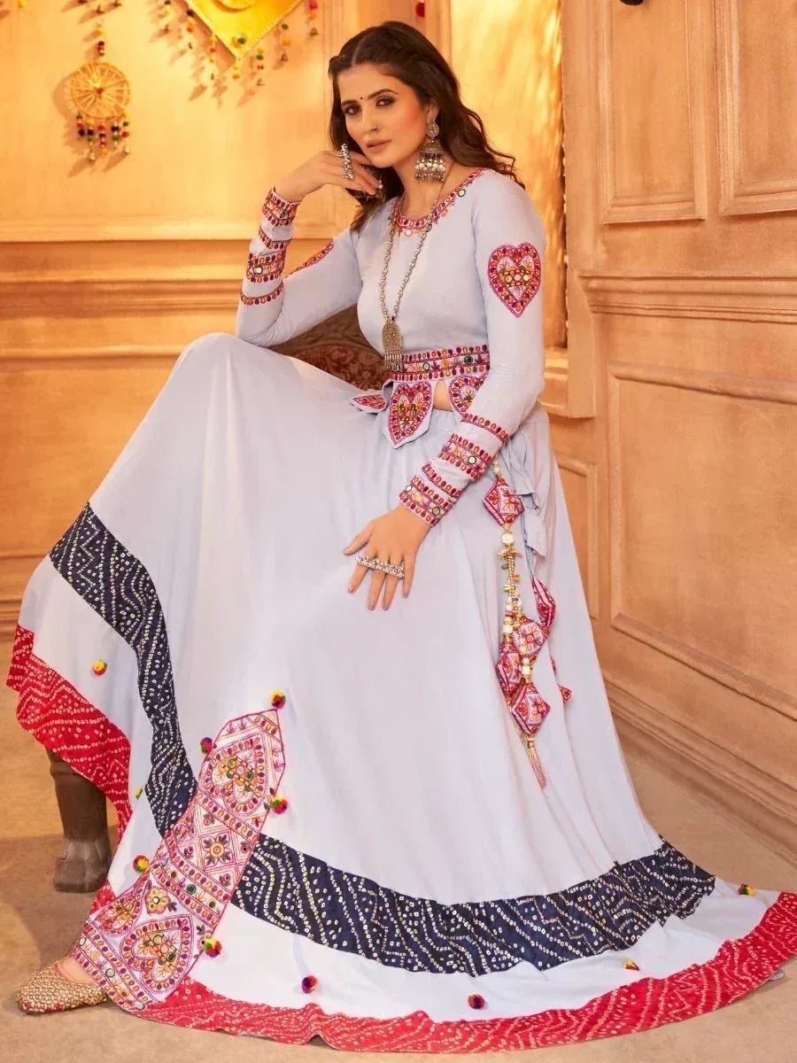 Elegant light blue ethnic gown with red and navy mirror work, perfect for Indian celebrations
