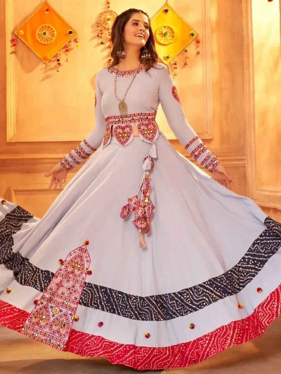 Woman in light blue embroidered ethnic gown with mirror work, perfect for Indian festivals and weddings
