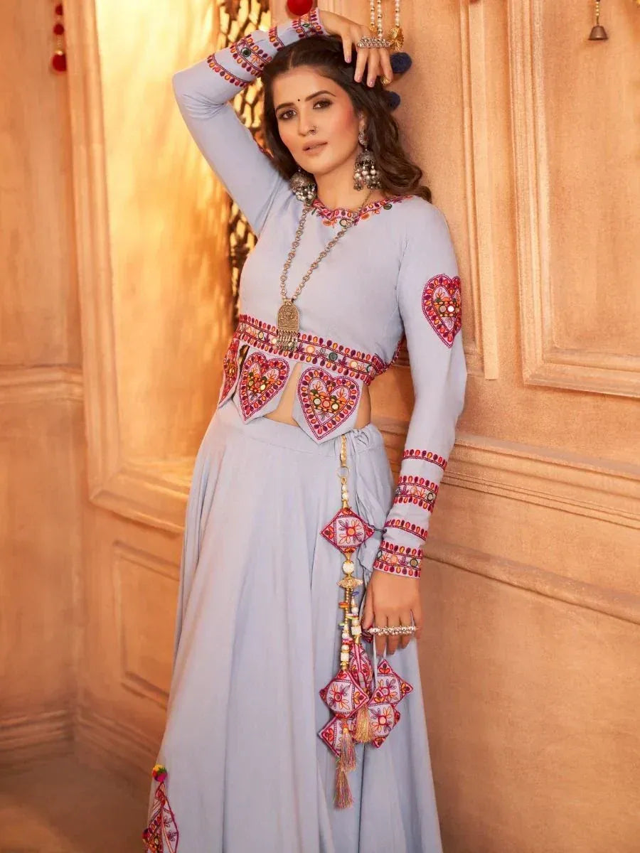 Light blue ethnic wear with heart embroidery, mirror work, and tassels, styled for Indian occasions