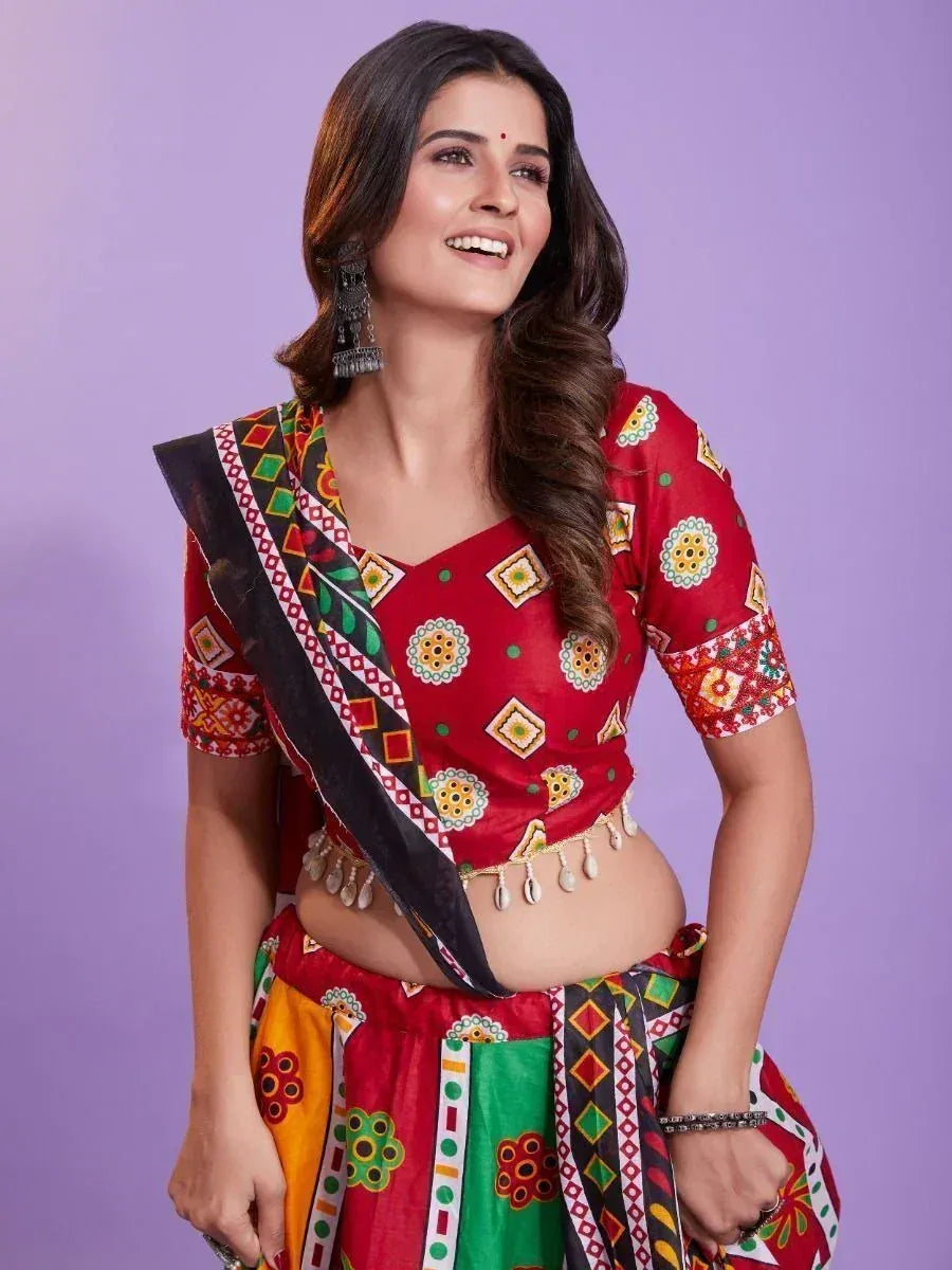 Vibrant red printed lehenga choli with ethnic patterns and mirror work, perfect for festive occasions.