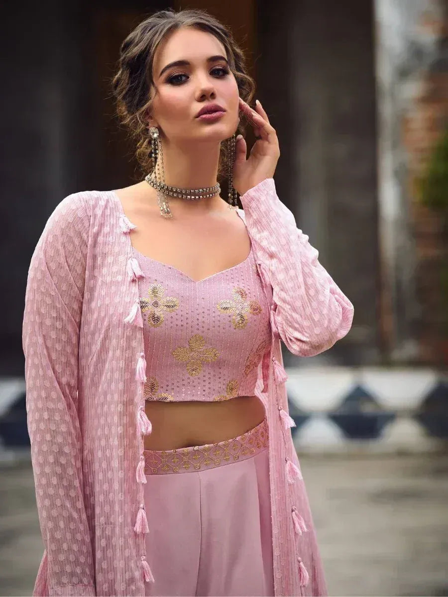 Woman wearing a pink embroidered crop top with long ethnic jacket and palazzo pants