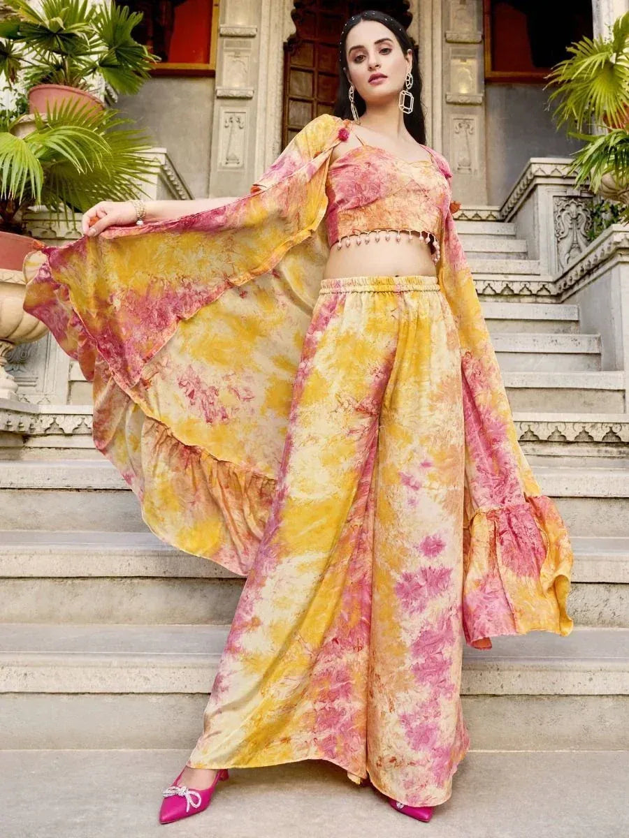 Woman in yellow and pink tie-dye ethnic co-ord set with palazzo pants and flared sleeves