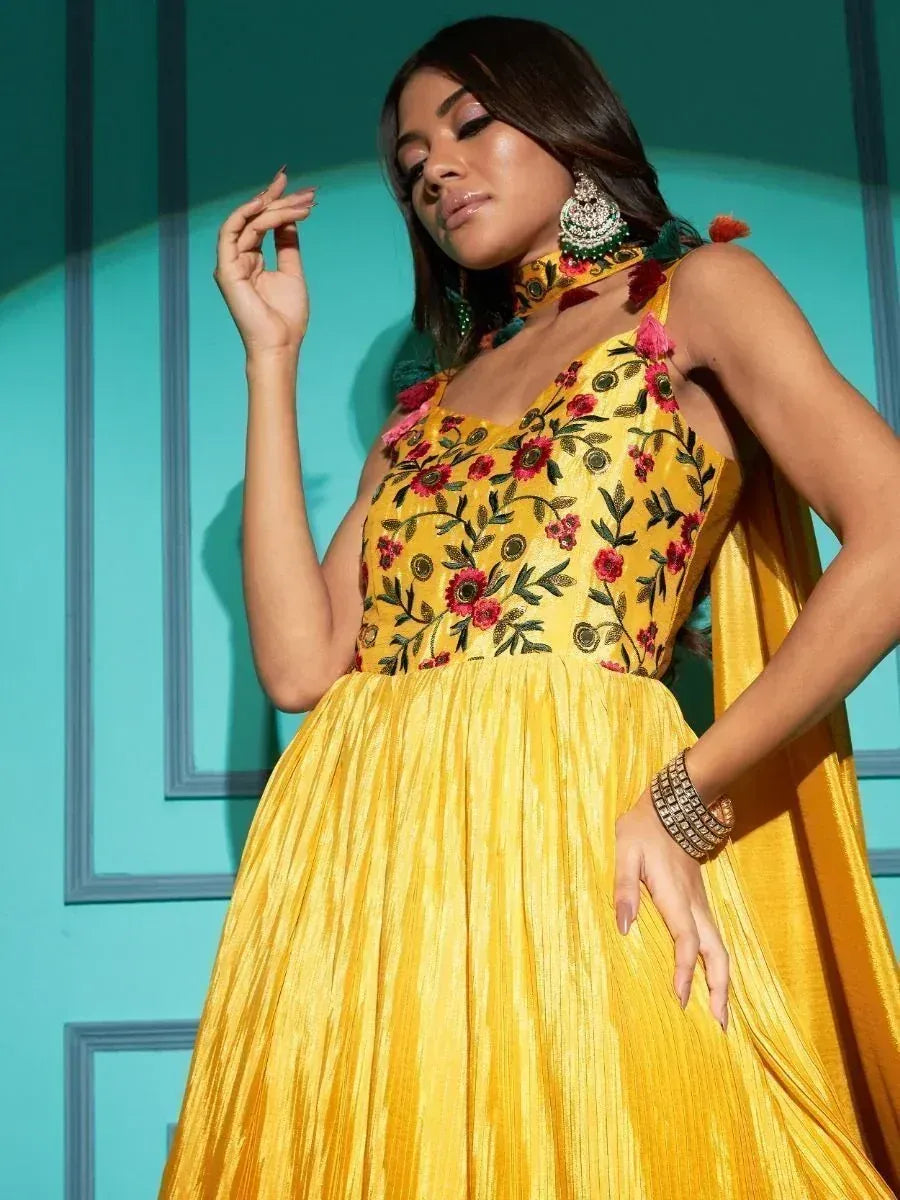 Yellow floral embroidered ethnic gown with pleated skirt, perfect for Indian occasions and festive wear.