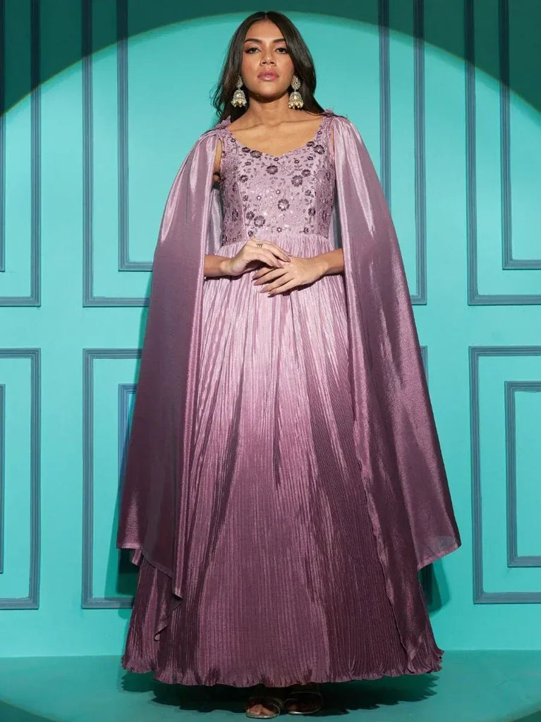 Elegant mauve ethnic gown with cape, pleated skirt, and floral embroidery for festive occasions