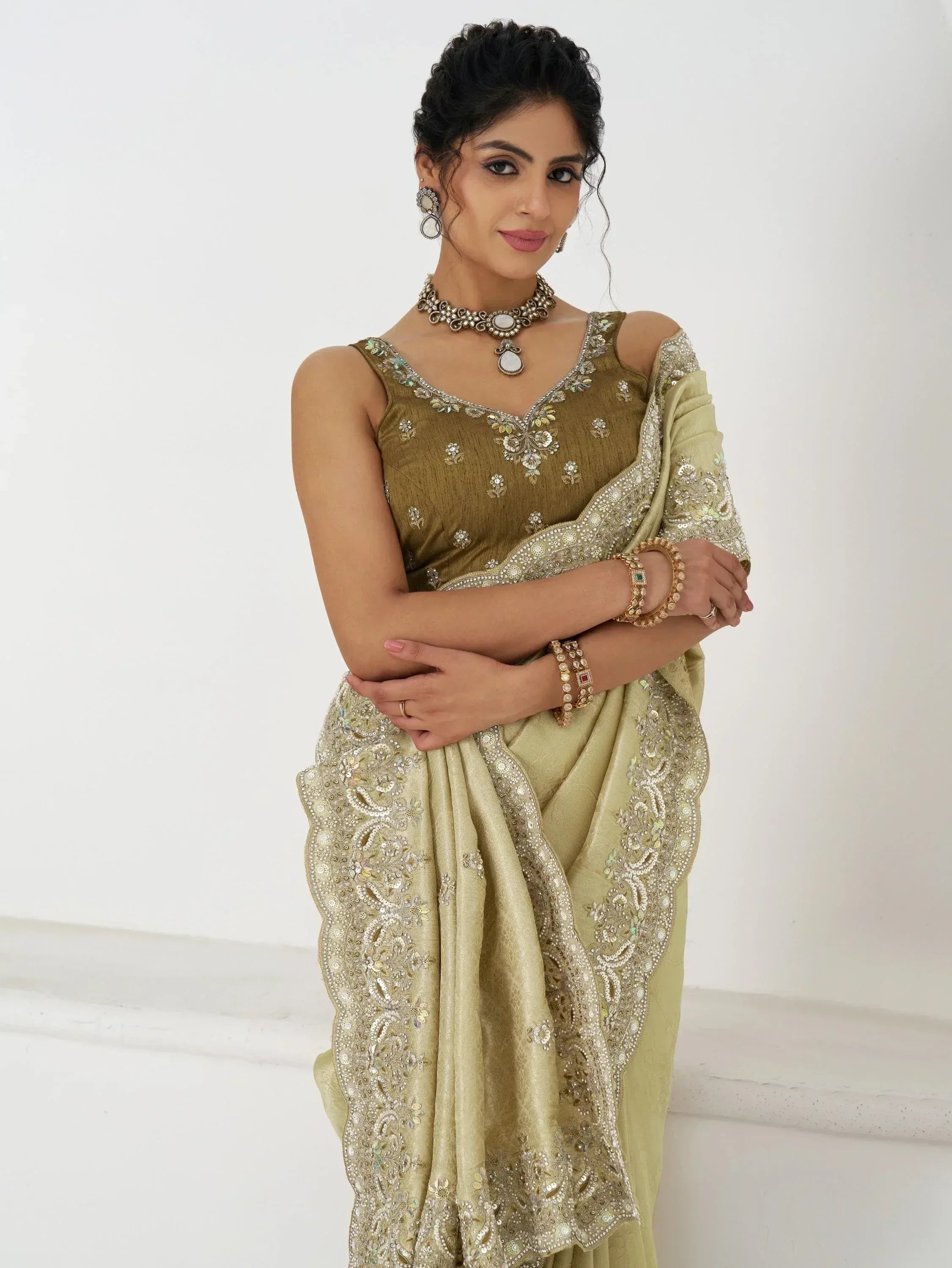 Elegant olive green saree with intricate gold embroidery and matching blouse, perfect for Indian ethnic occasions.