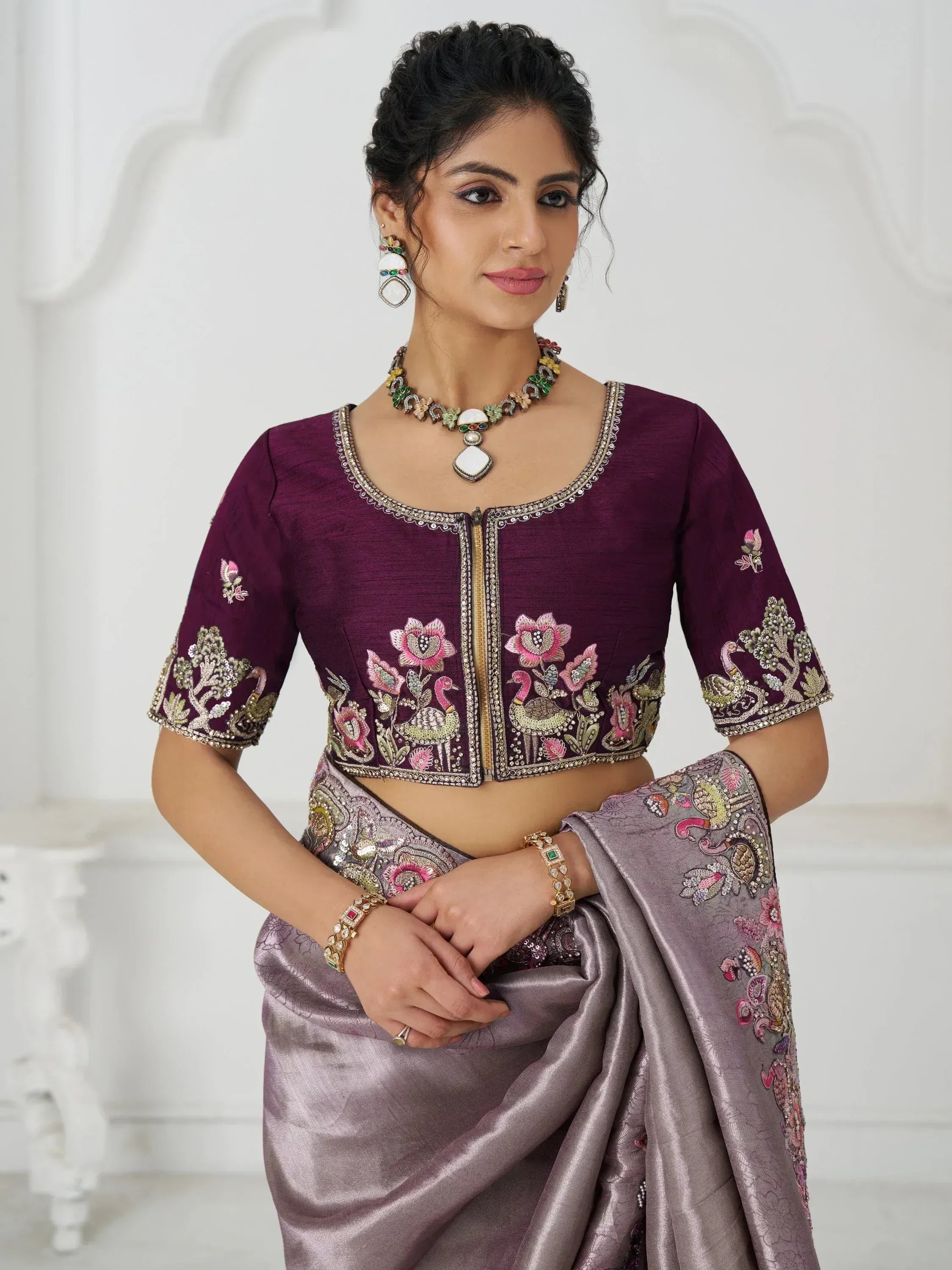 Purple embroidered blouse with floral peacock design, paired with grey saree for Indian ethnic wear