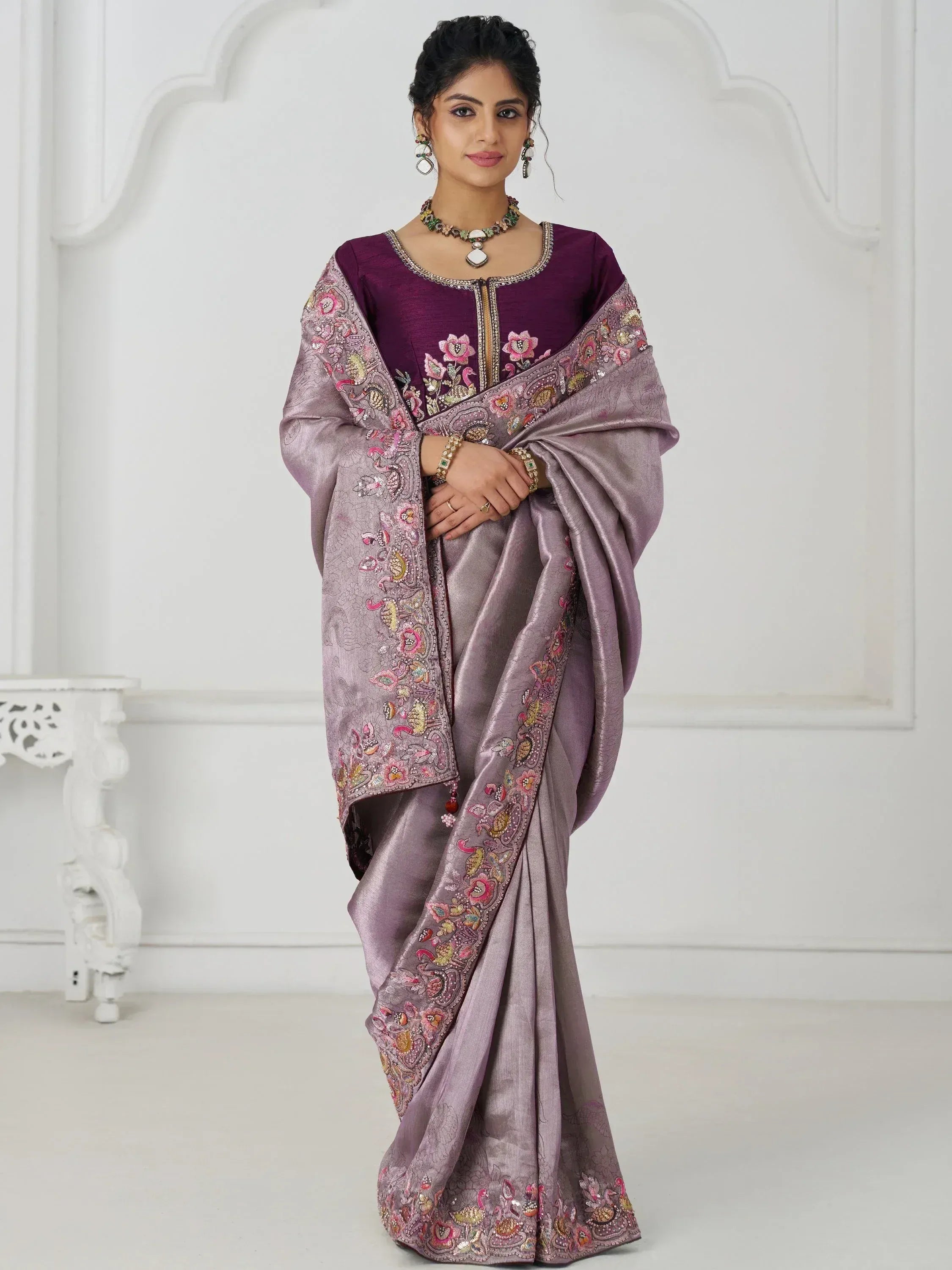 Elegant purple embroidered saree with floral and peacock motifs, perfect for Indian ethnic wear occasions.