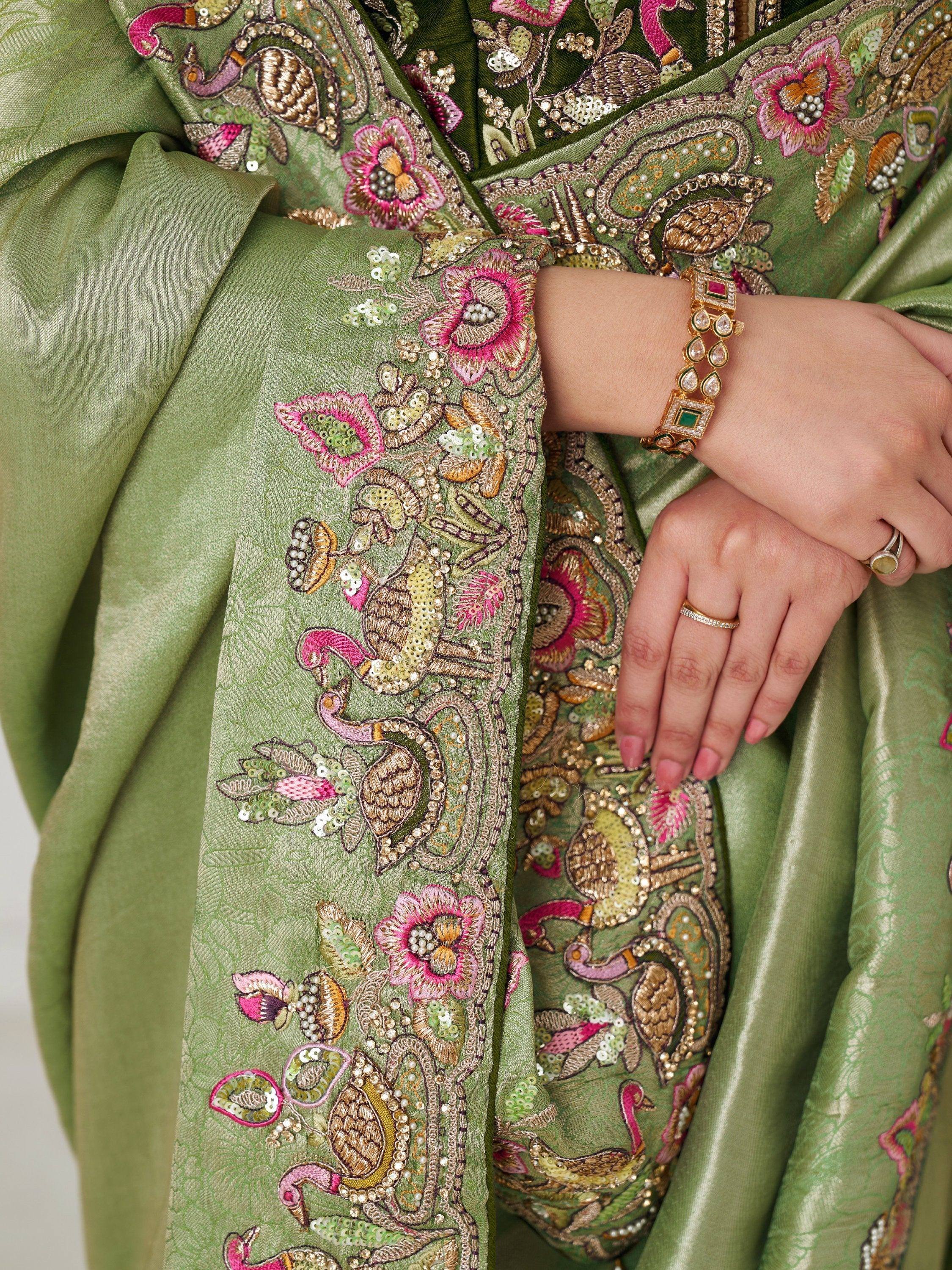 Green ethnic gown with peacock and floral embroidery, sequins, and pearl detailing for festive occasions