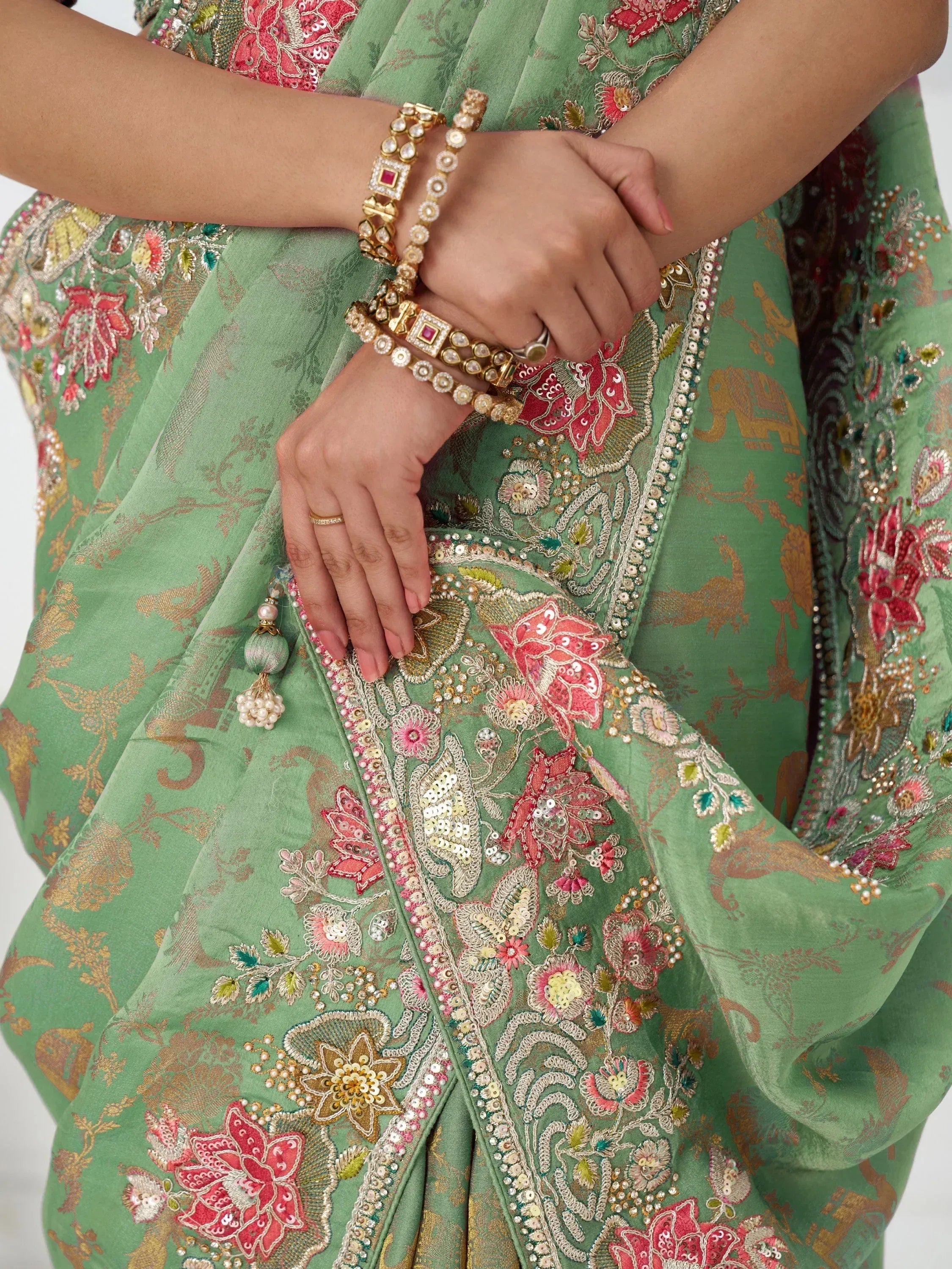 Green embroidered lehenga choli with floral sequin work and gold jewelry