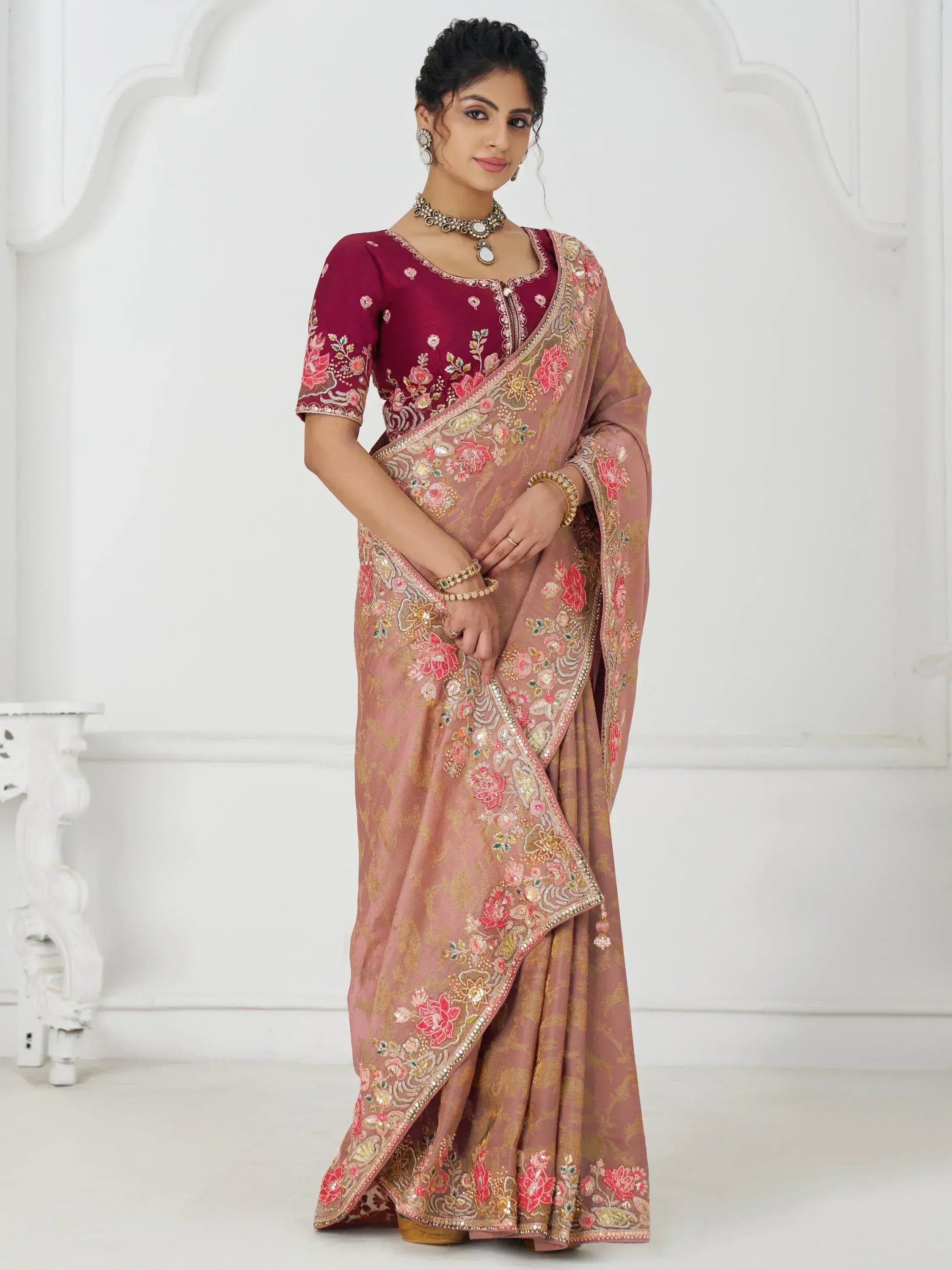 Elegant pink and maroon embroidered saree with floral zari work, perfect for Indian ethnic occasions.