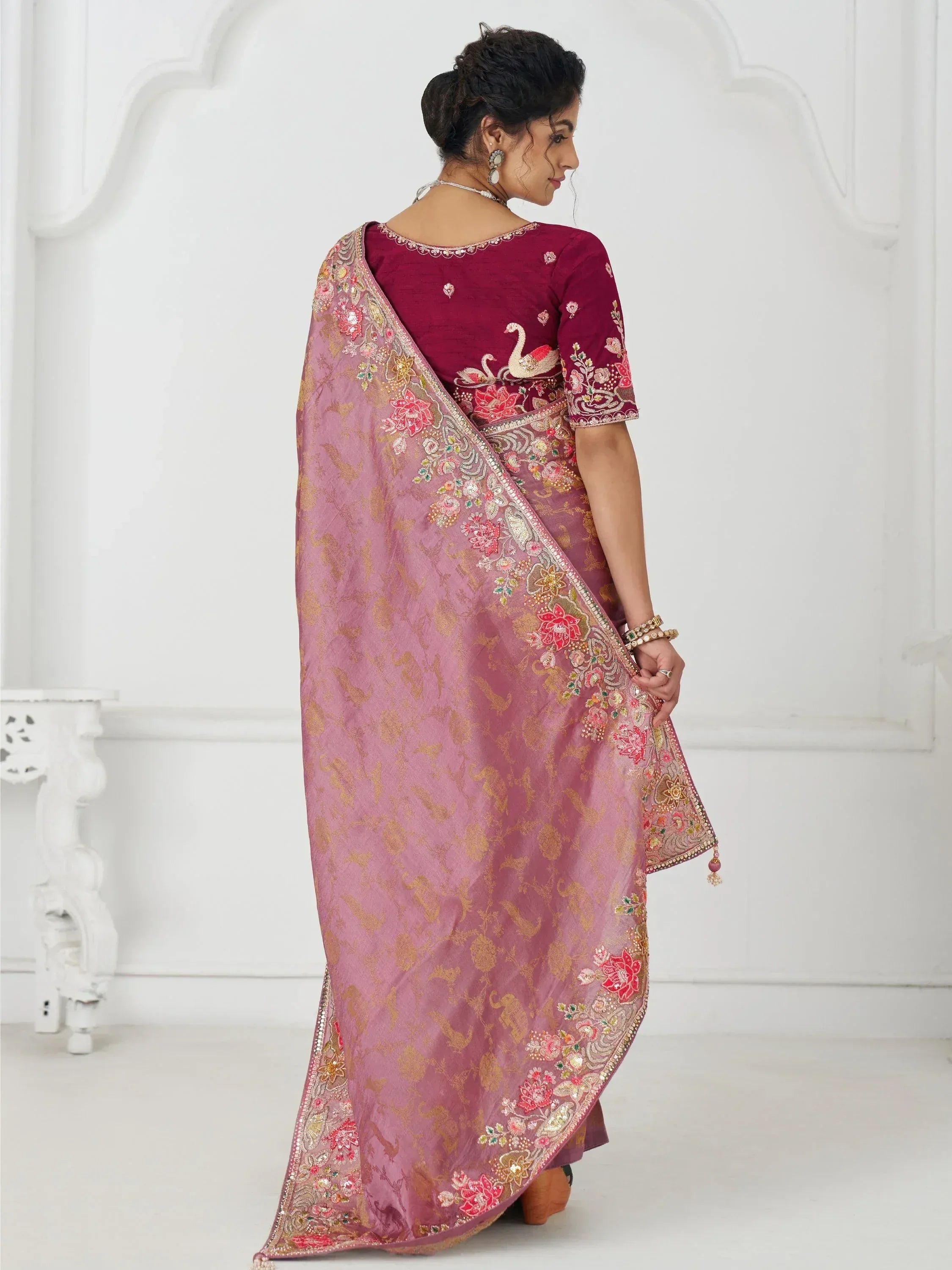 Elegant maroon and pink embroidered saree with floral and swan motifs, perfect for Indian ethnic occasions