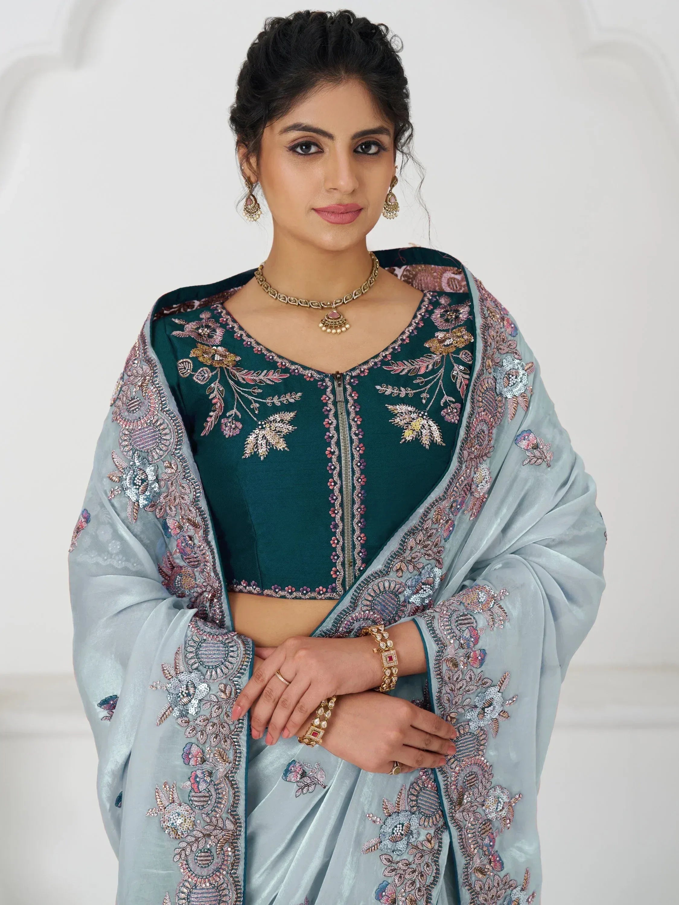 Woman in teal embroidered crop top with light blue floral dupatta, Indian ethnic wear