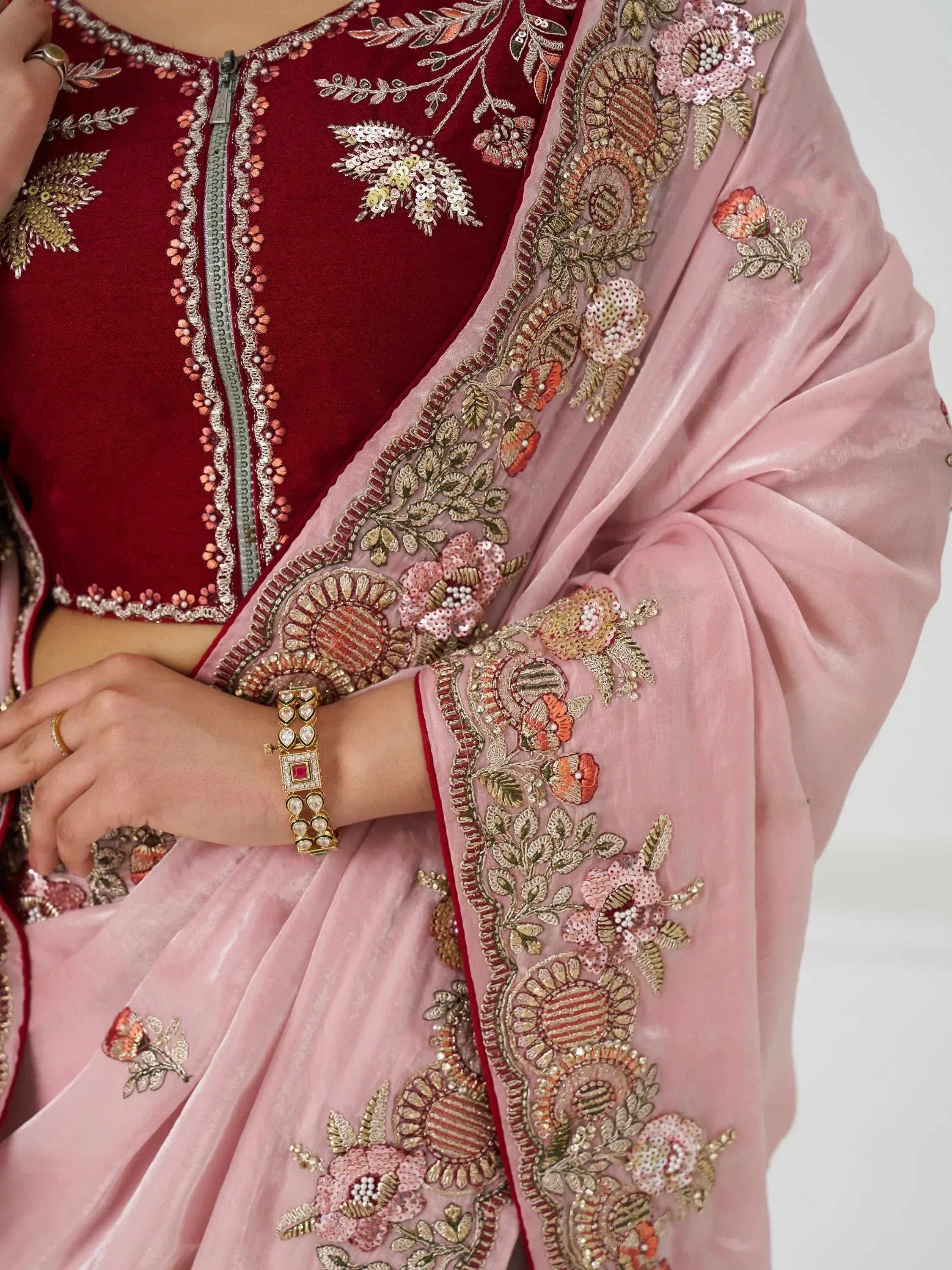Maroon velvet blouse with floral embroidery paired with pink embroidered dupatta, showcasing Indian ethnic wear details.