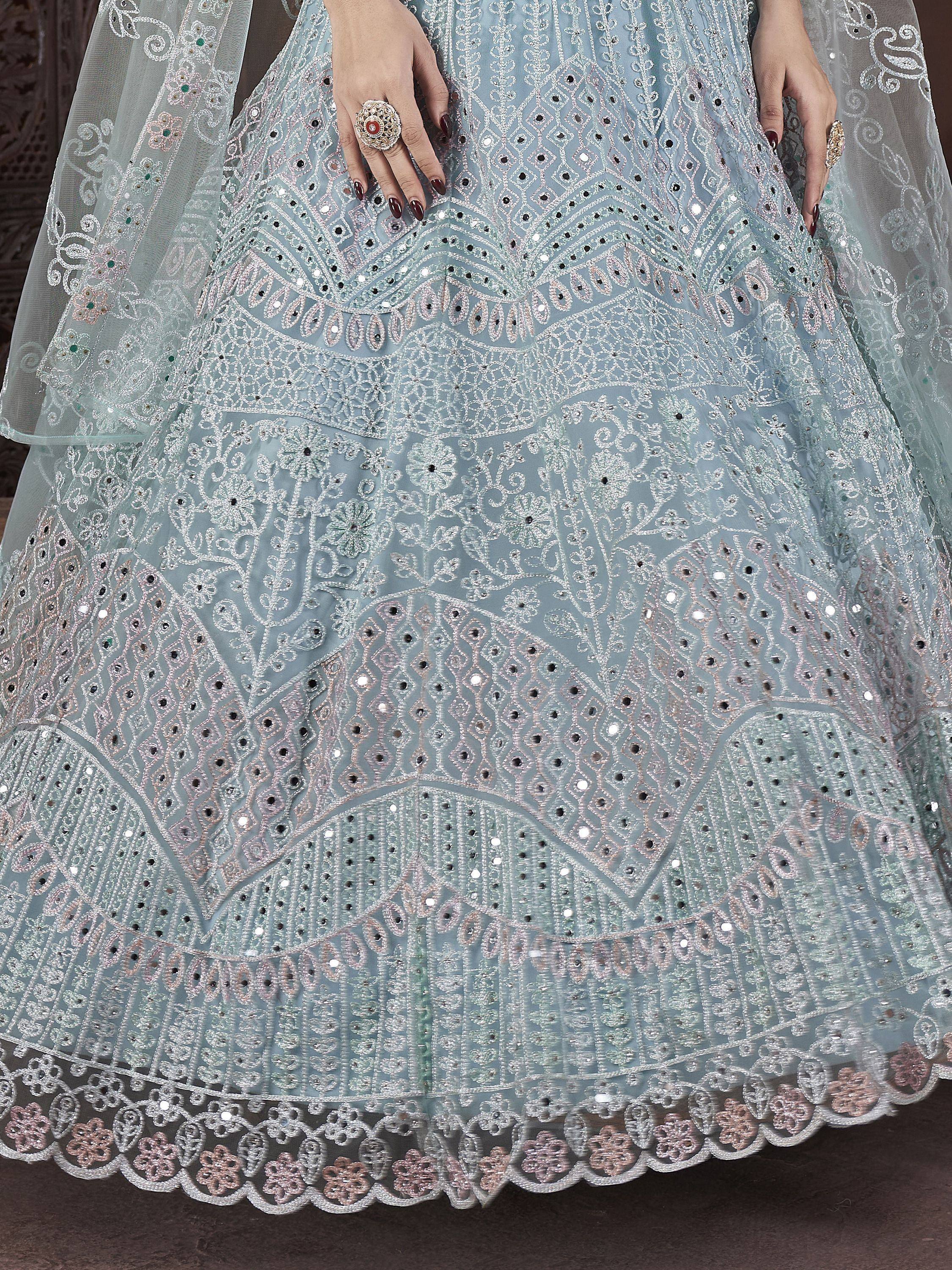 Light blue embroidered lehenga with intricate floral patterns, mirror work, and scalloped hem for Indian ethnic wear