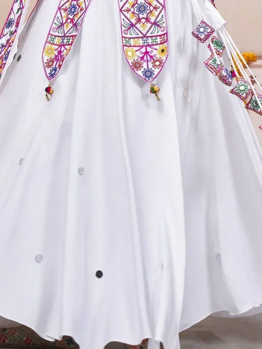 White ethnic gown with colorful floral embroidery and tassels, perfect for festive occasions