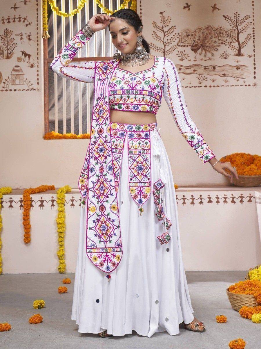 White embroidered lehenga choli with colorful mirror work, perfect for Indian ethnic occasions