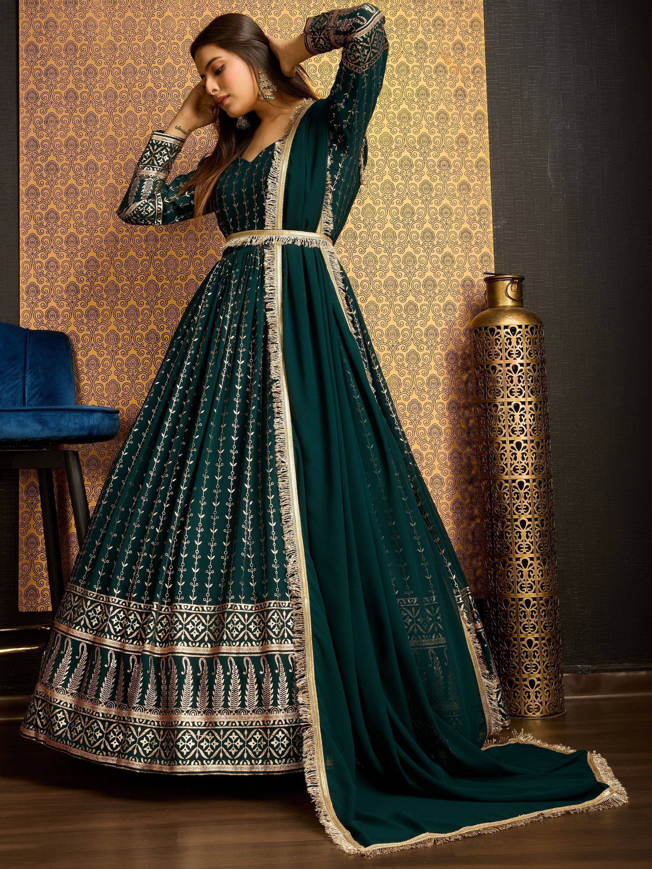 Emerald green ethnic gown with gold embroidery, perfect for Indian occasions and festive wear.