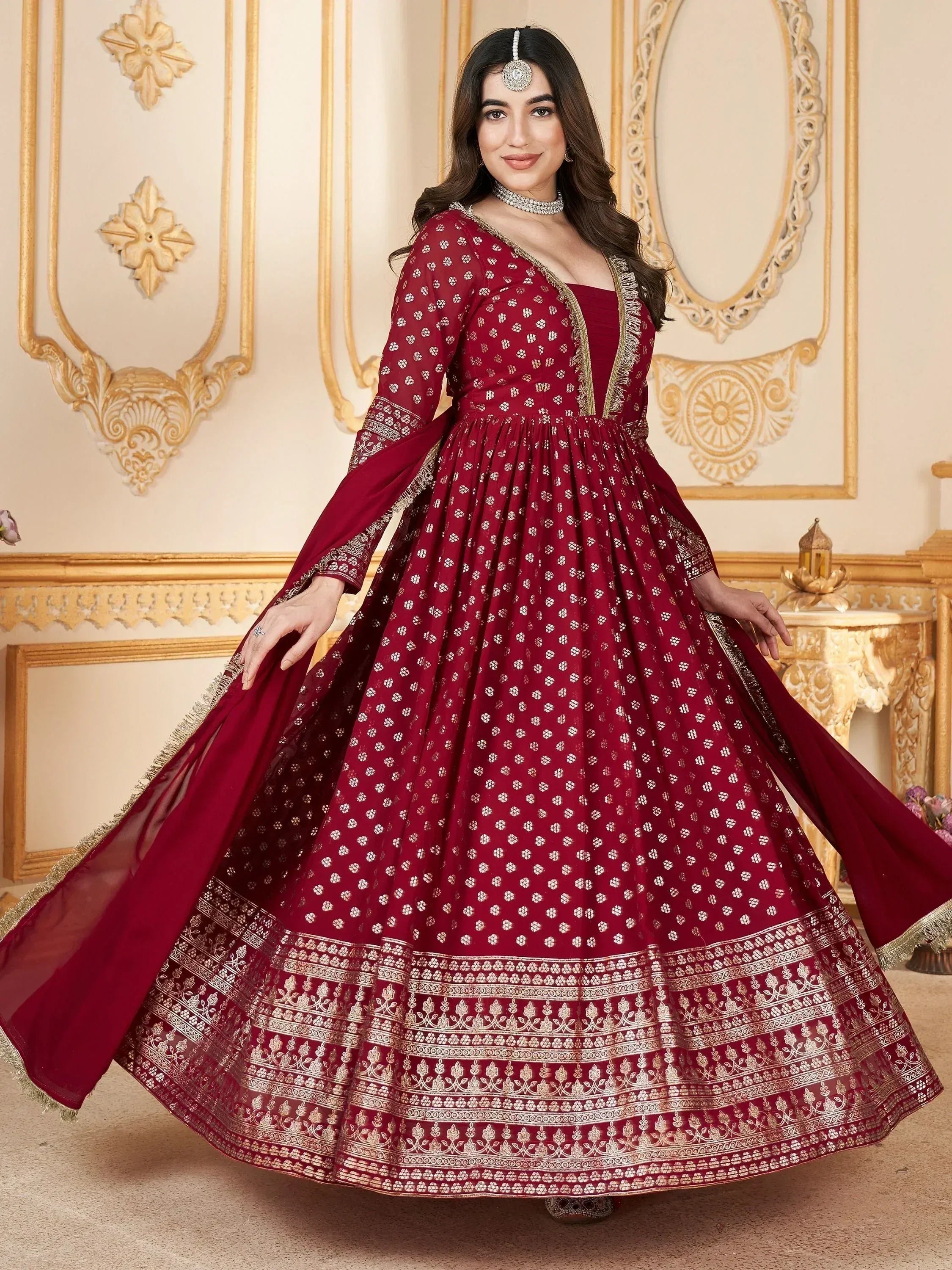 Maroon ethnic gown with gold embroidery, perfect for Indian weddings and festive occasions