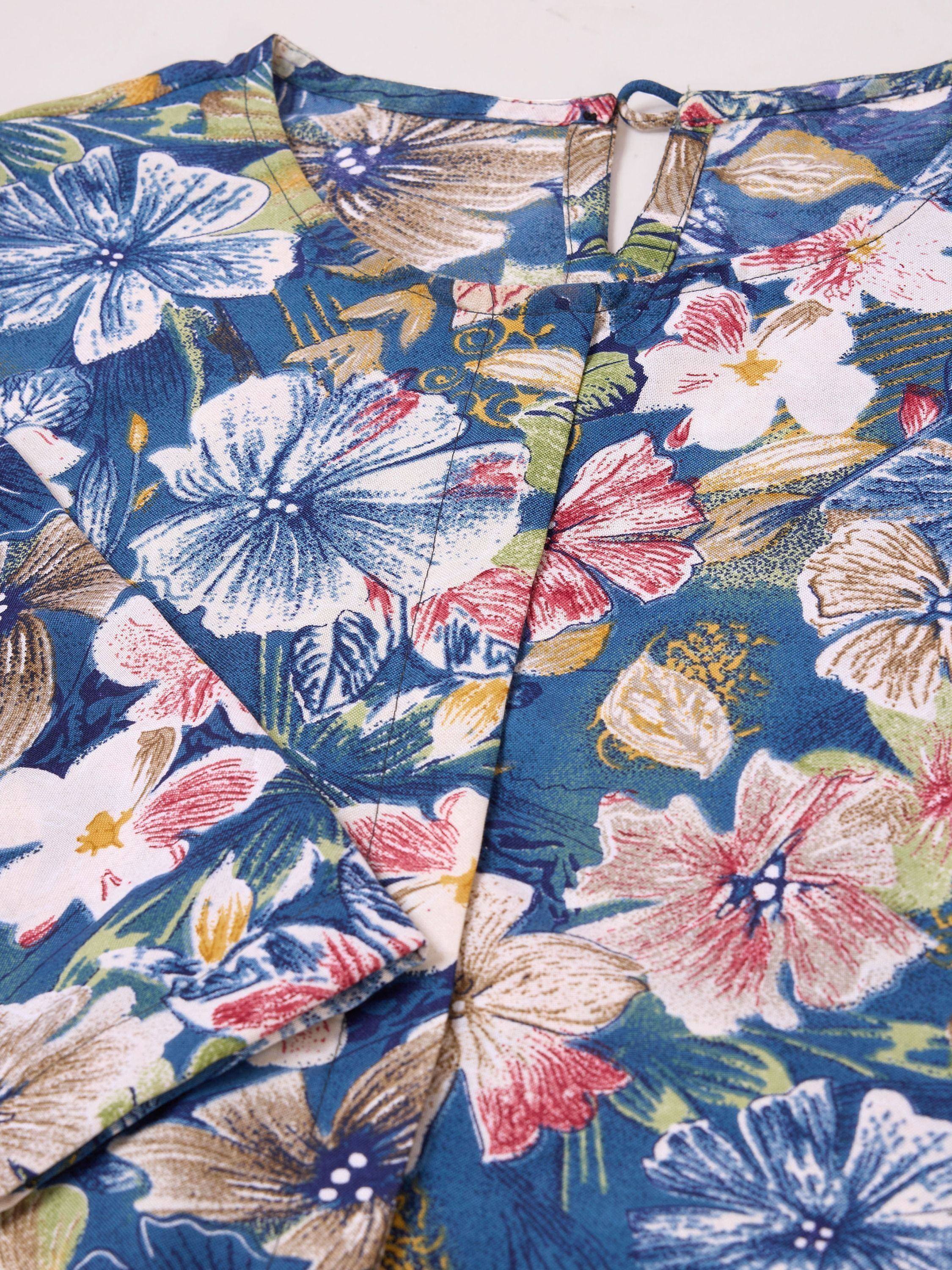 Blue floral print ethnic gown with vibrant hibiscus design and tie-back detail