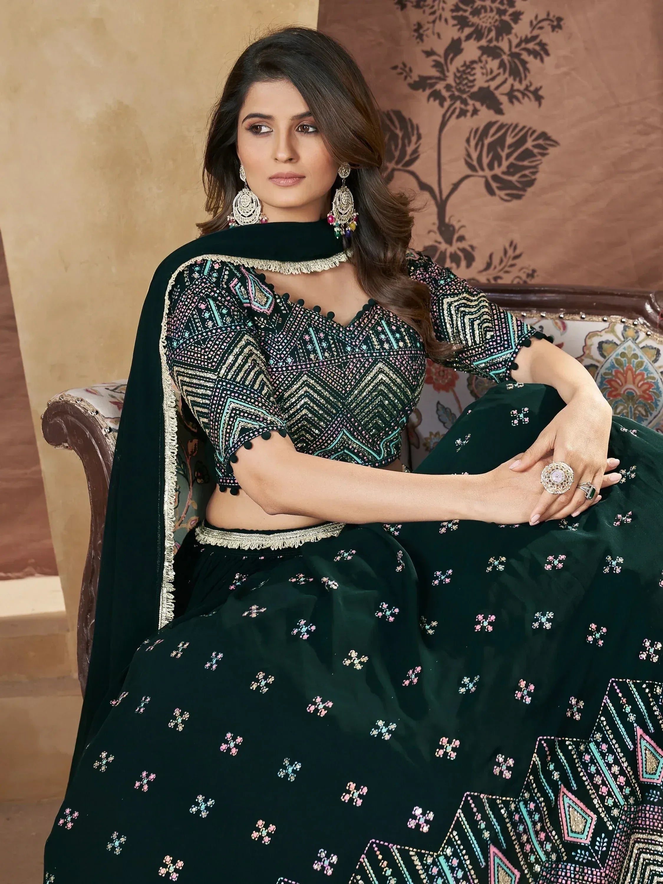 Elegant dark green embroidered lehenga choli with geometric patterns and matching dupatta, perfect for Indian ethnic occasions.