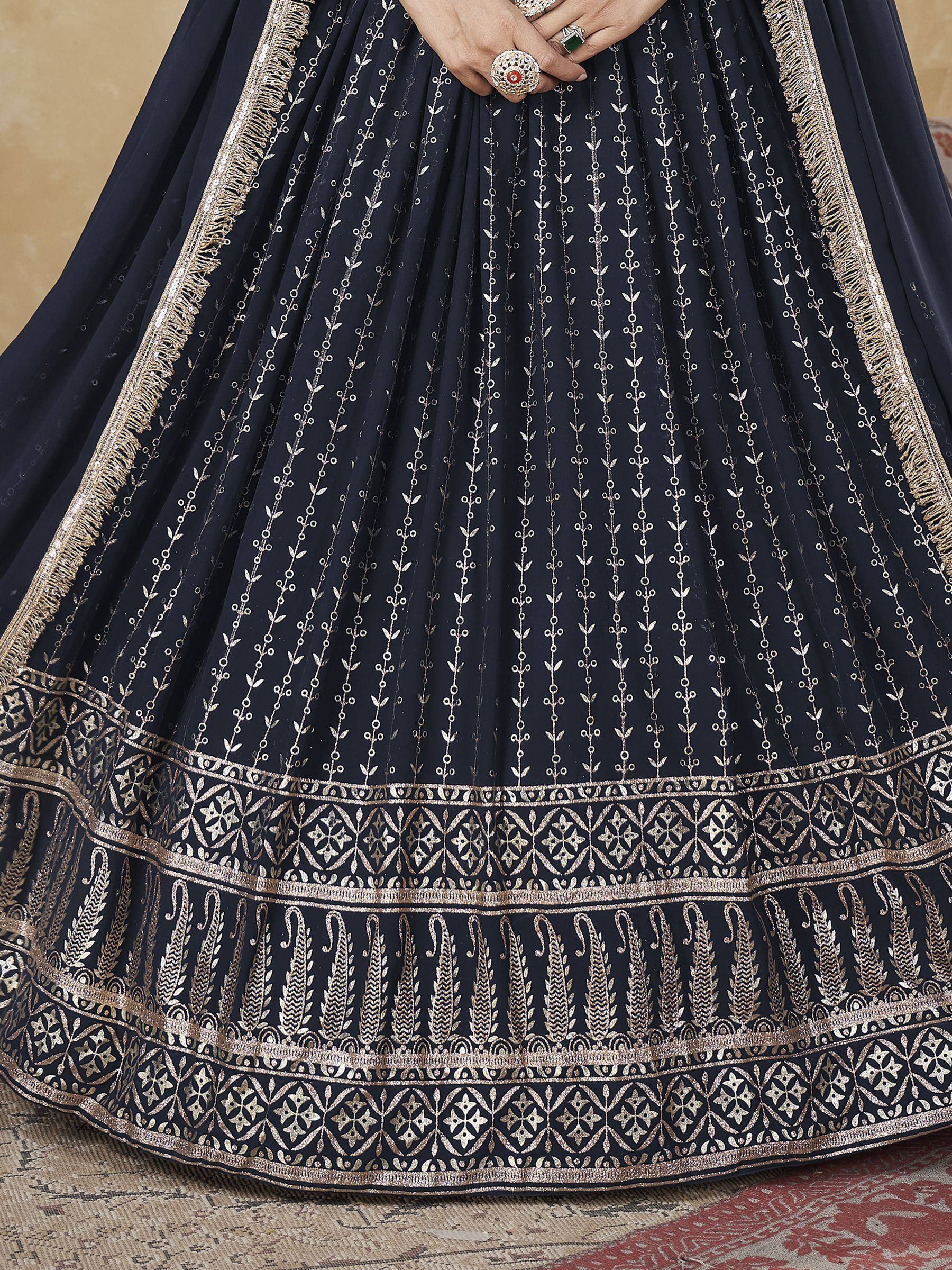 Navy blue lehenga with gold embroidery and intricate border design, perfect for Indian ethnic wear