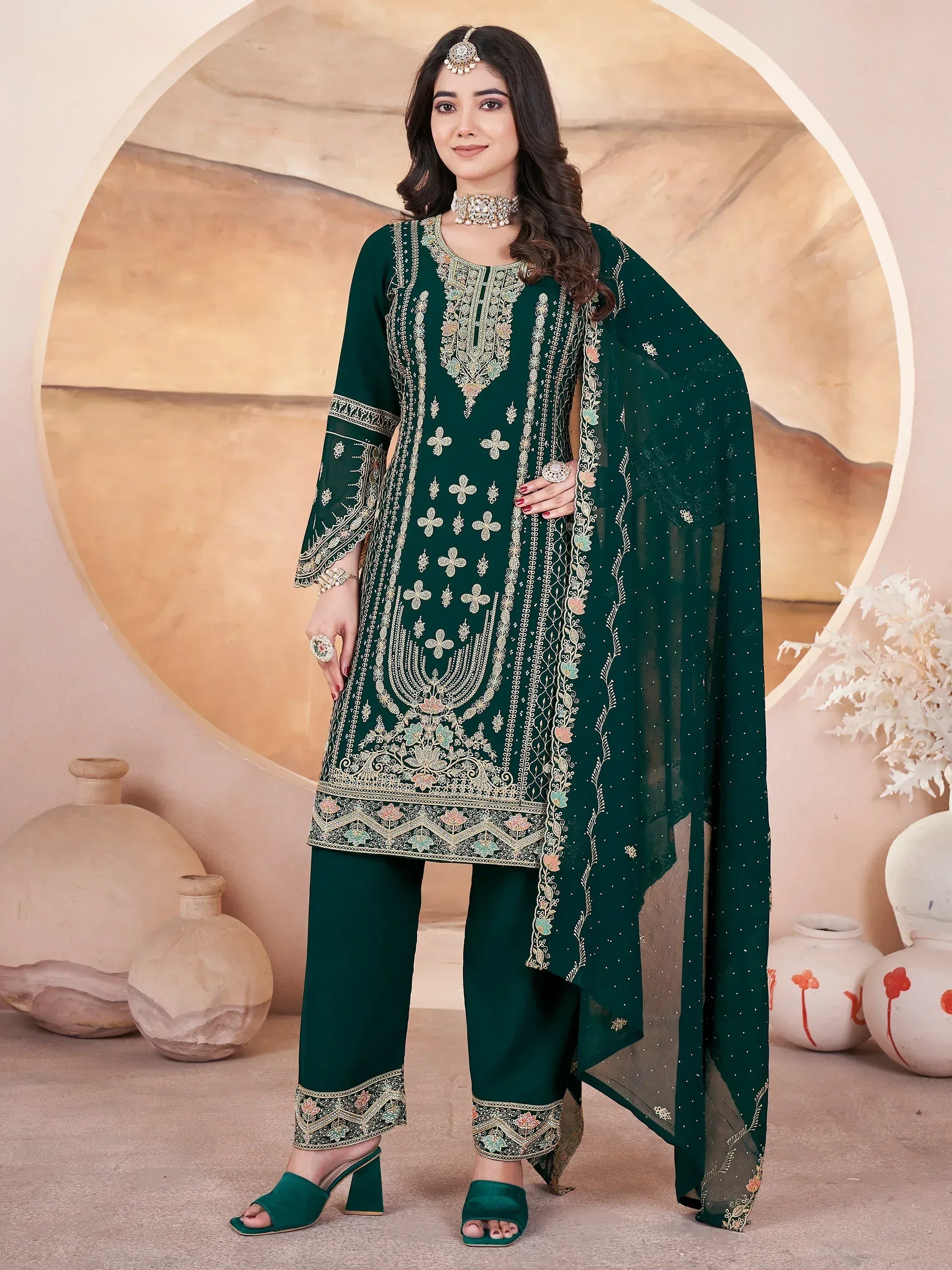 Emerald green embroidered salwar kameez with floral motifs and matching dupatta, perfect for festive occasions.